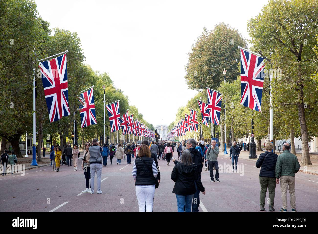 People walk on The Mall in central London as people gather around Buckingham Palace on the first Saturday since the funeral of Queen Elizabeth II. Stock Photo