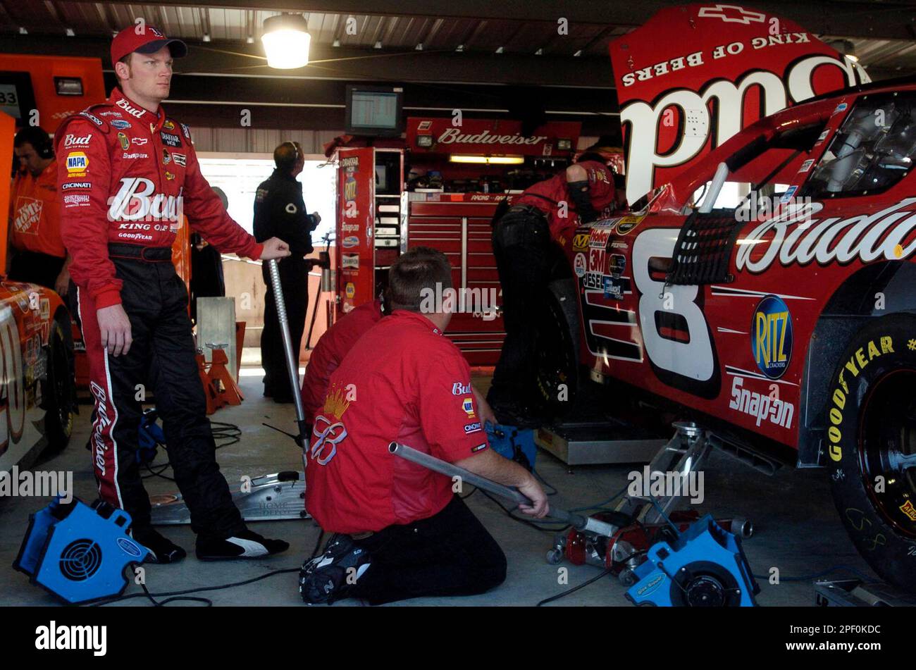 Dale Earnhardt Jr. stands in the garage as crew members work on his car  Friday, April 16, 2004, in preparation for the NASCAR Advance Auto Parts  500 at Martinsville Seedway in Martinsville,, image size:1300x951