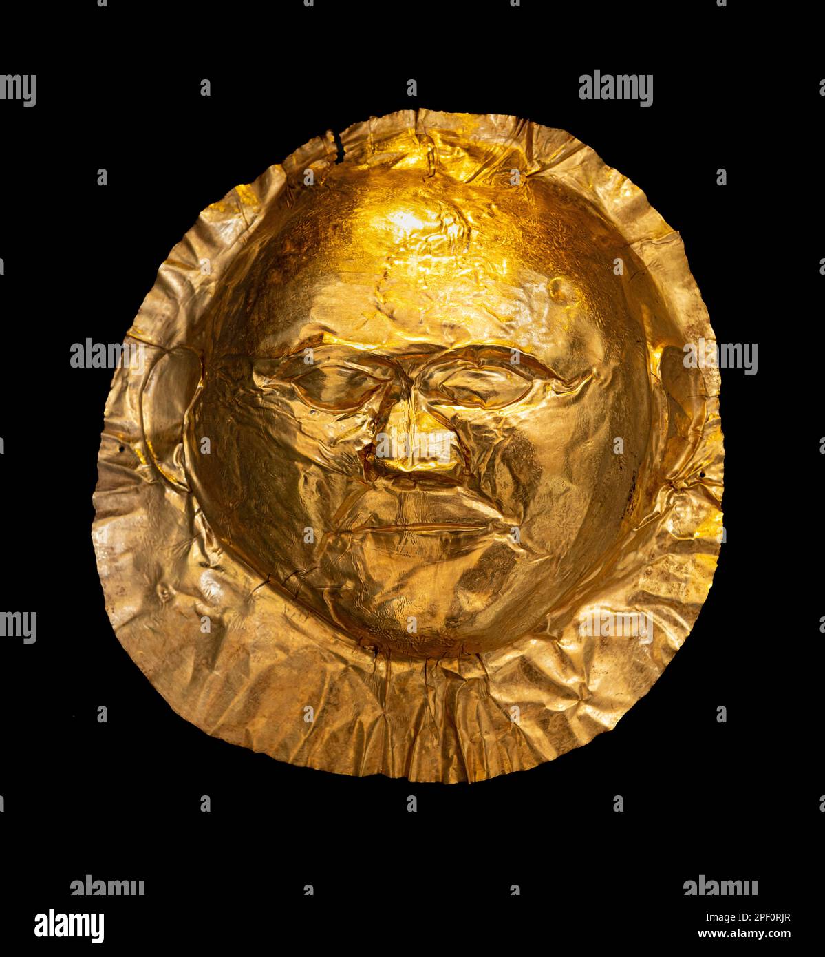 A 16th Century BC,  gold, funerary mask from grave V of grave circle A at Ancient Mycenae, Peloponnese, Greece. Stock Photo