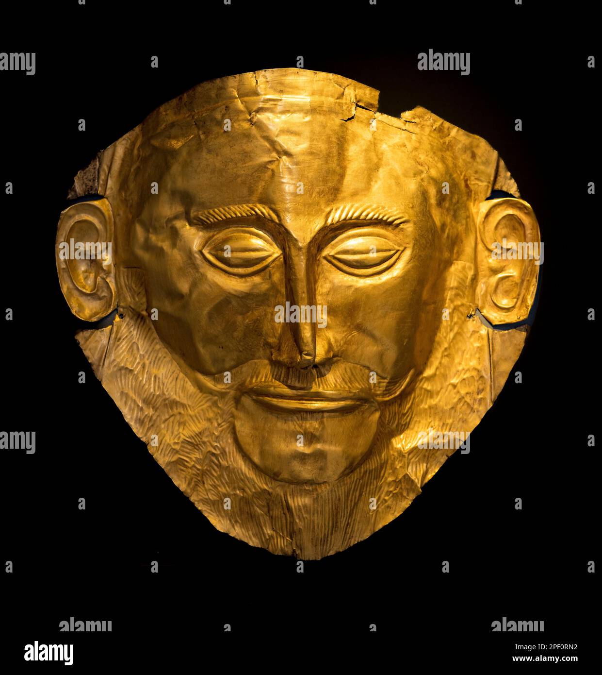 A 16th Century BC,  gold, funerary mask known as the Mask of Agamemnon, from from grave V of grave circle A at Ancient Mycenae, Peloponnese, Greece. Stock Photo