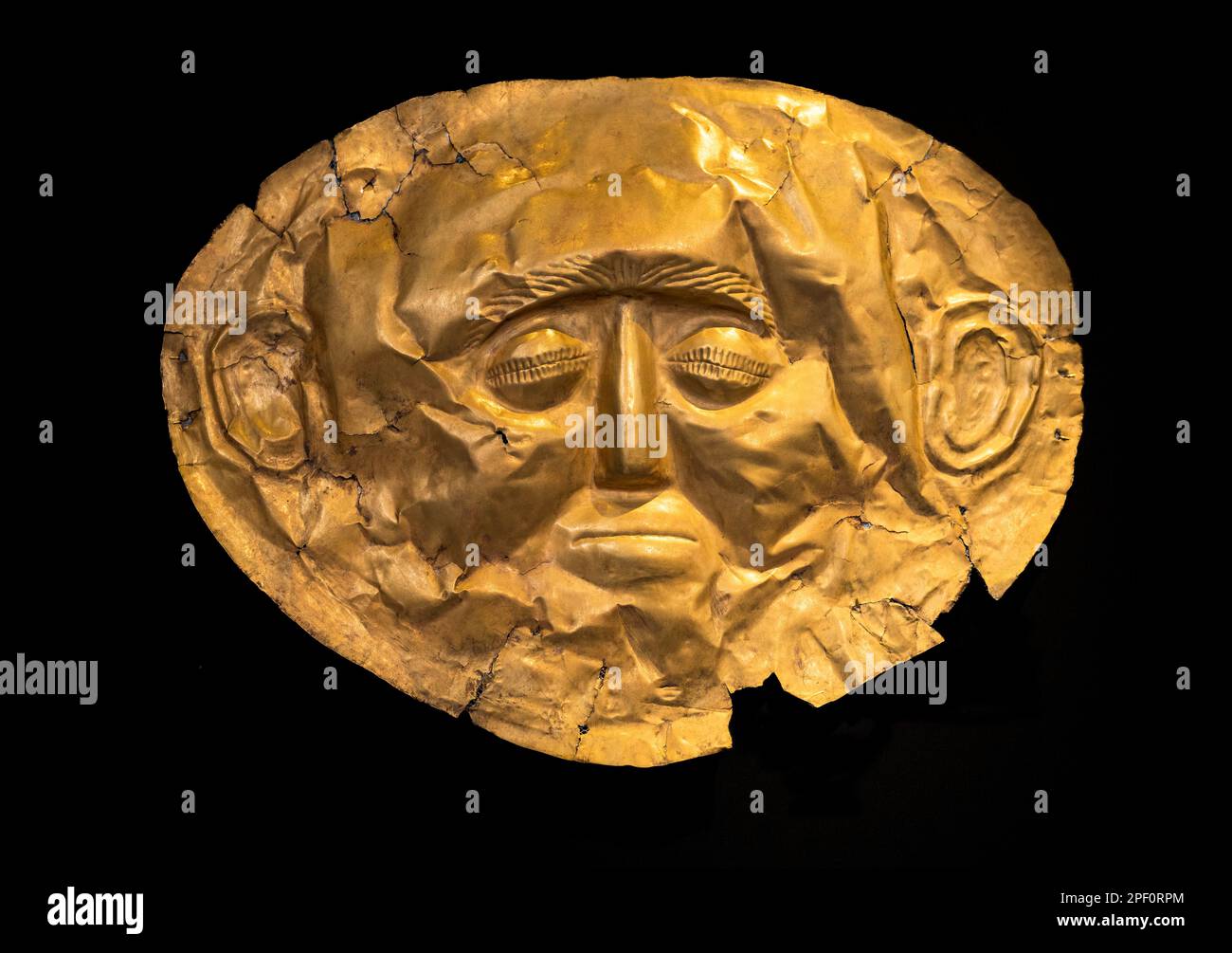 A 16th Century BC,  gold, funerary mask from grave IV of grave circle A at Ancient Mycenae, Peloponnese, Greece. Stock Photo