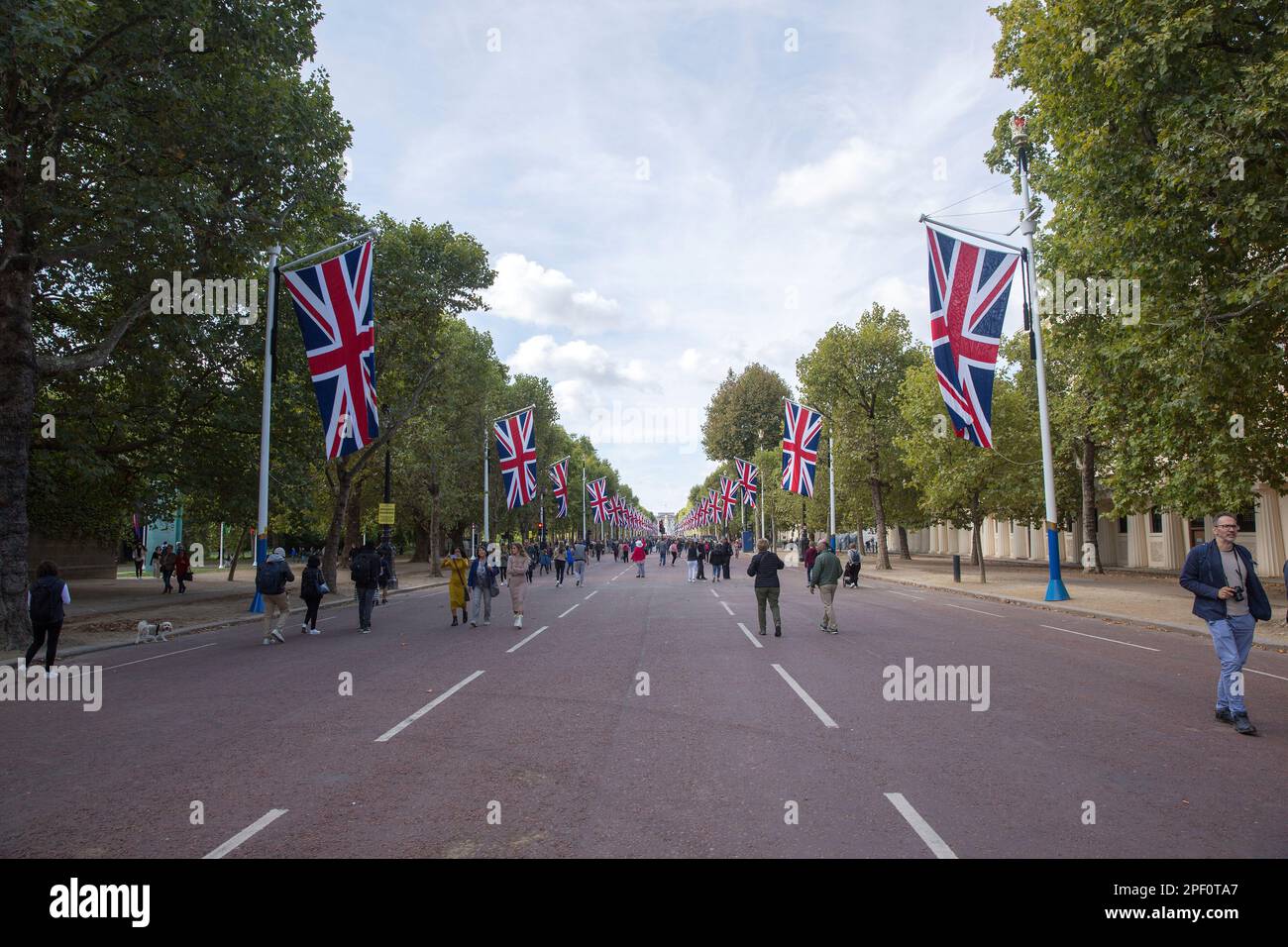 People walk on The Mall in central London as people gather around Buckingham Palace on the first Saturday since the funeral of Queen Elizabeth II. Stock Photo