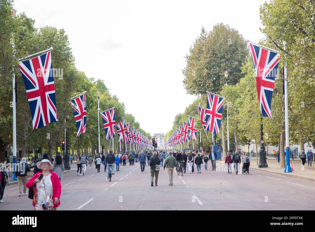 People walk on The Mall in central London as people gather around Buckingham Palace on the first Saturday since the funeral of Queen Elizabeth II. Stock Photo