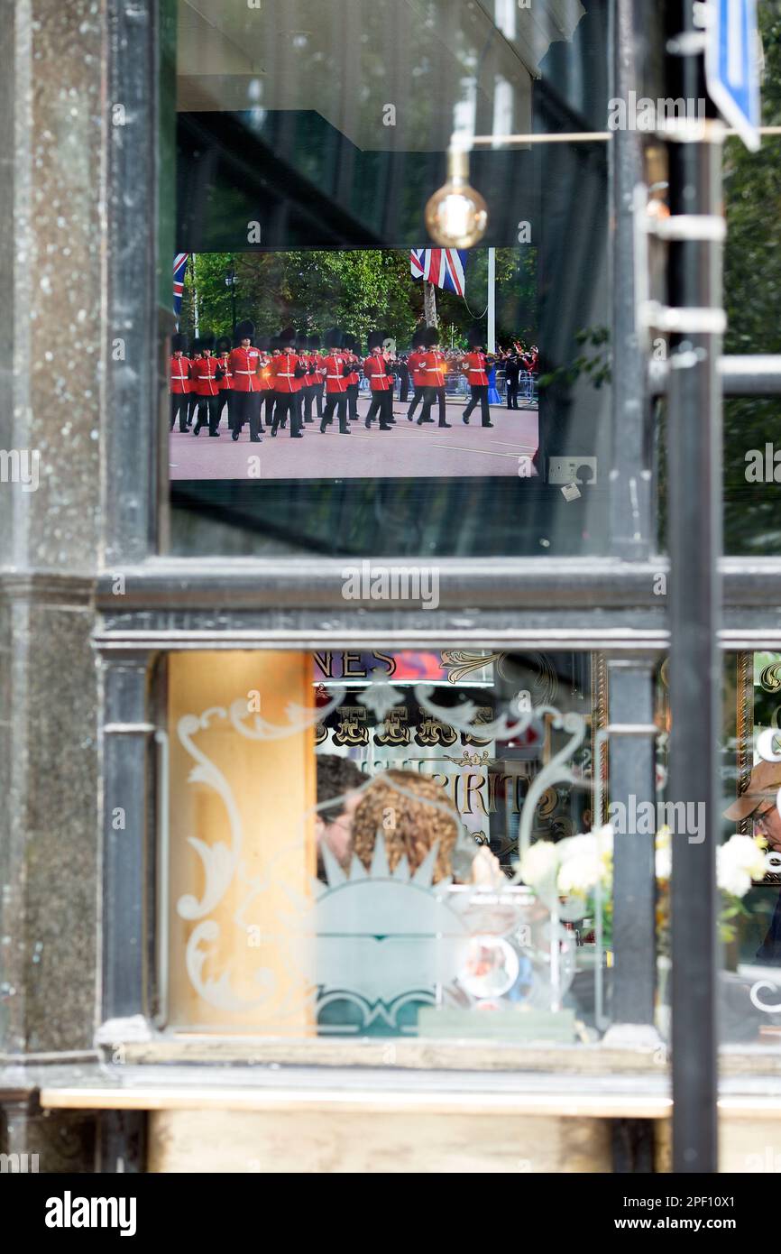 A TV screen displays the funeral day coverage of the late Queen