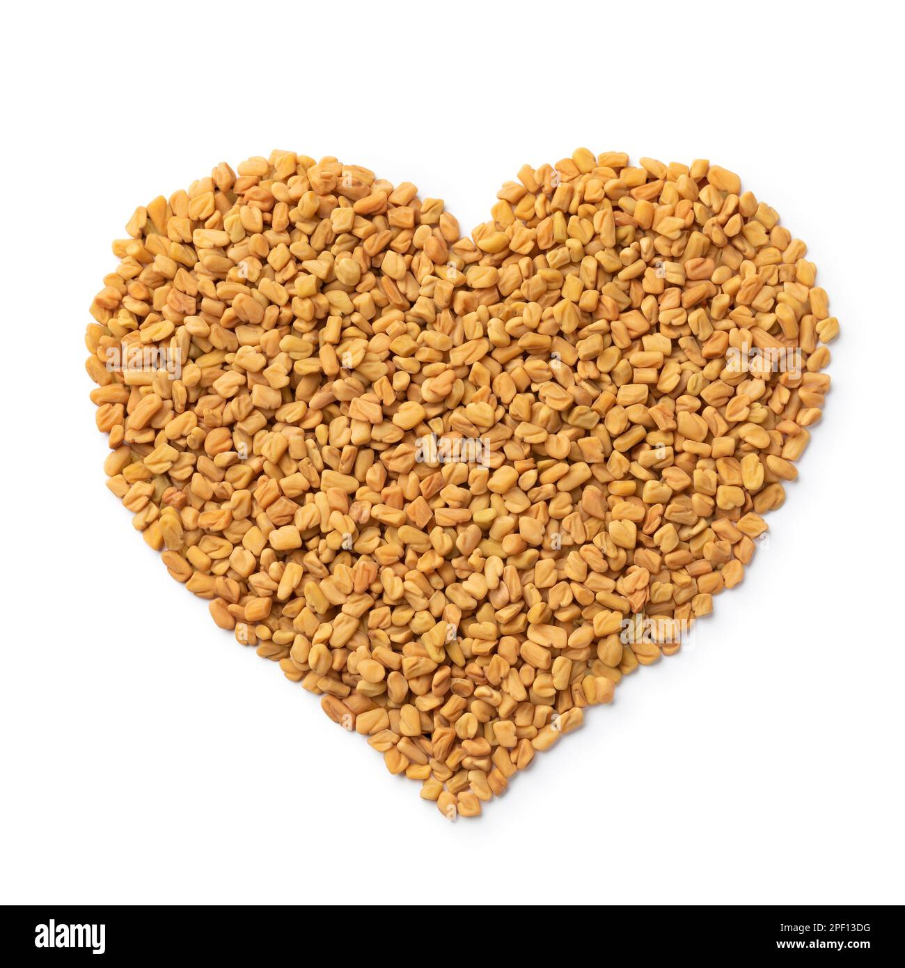 Fenugreek seeds in heart shape isolated on white background Stock Photo