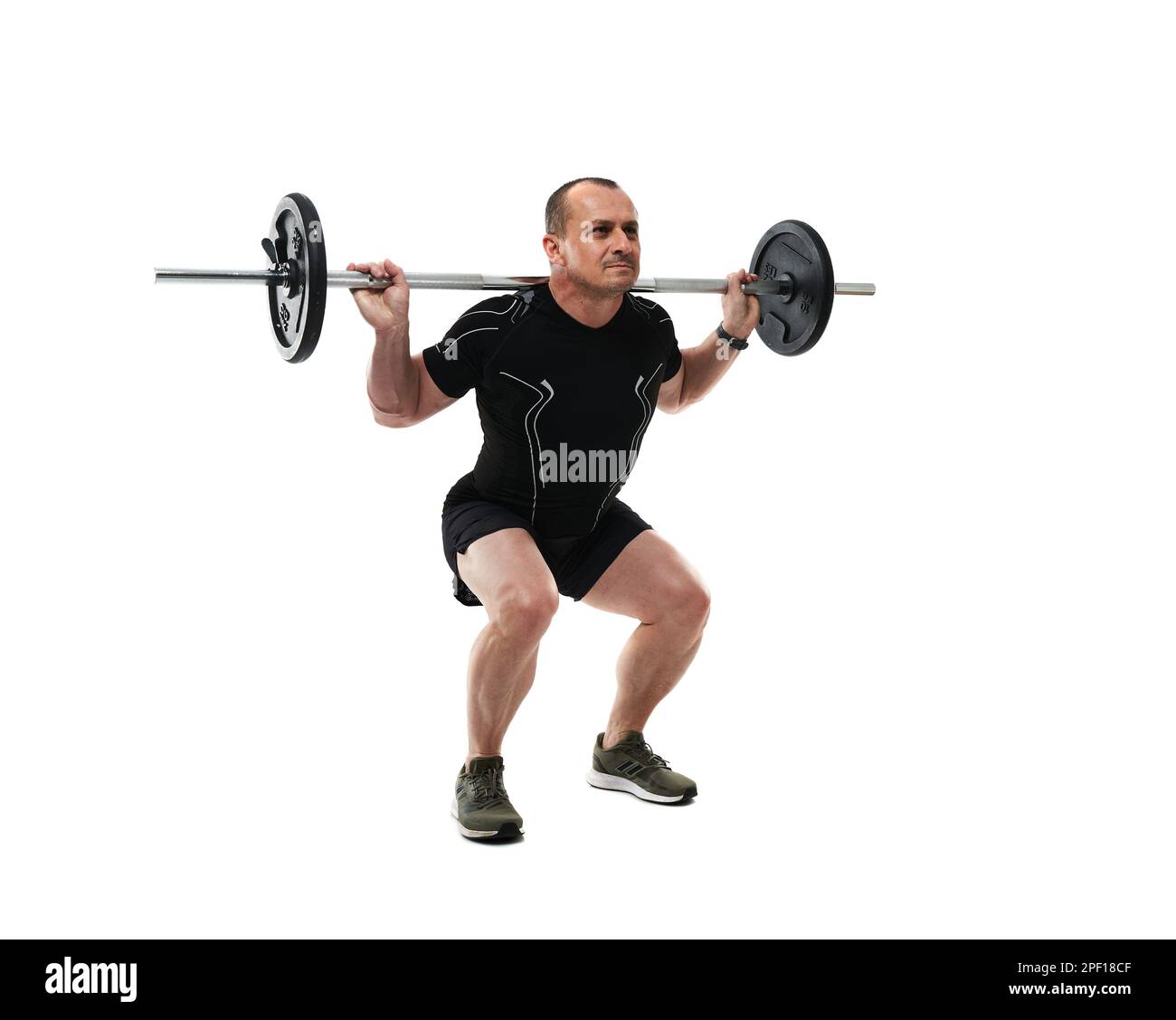 Athletic middle age man doing squats fitness workout with barbell, isolated on white background Stock Photo
