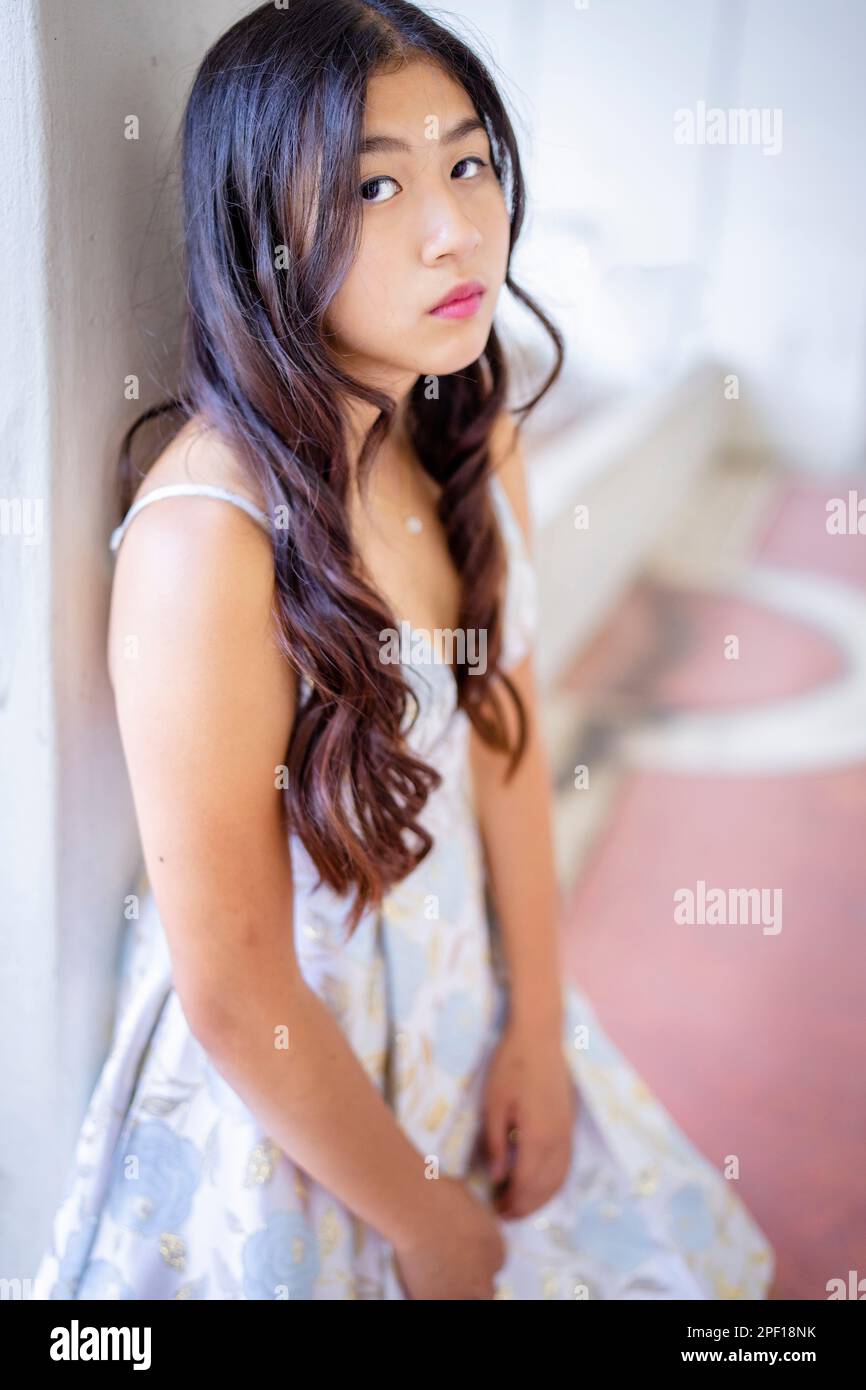 Moody Looking Beautiful Asian Teen in Prom Dress | Side View | Outdoors  Stock Photo - Alamy