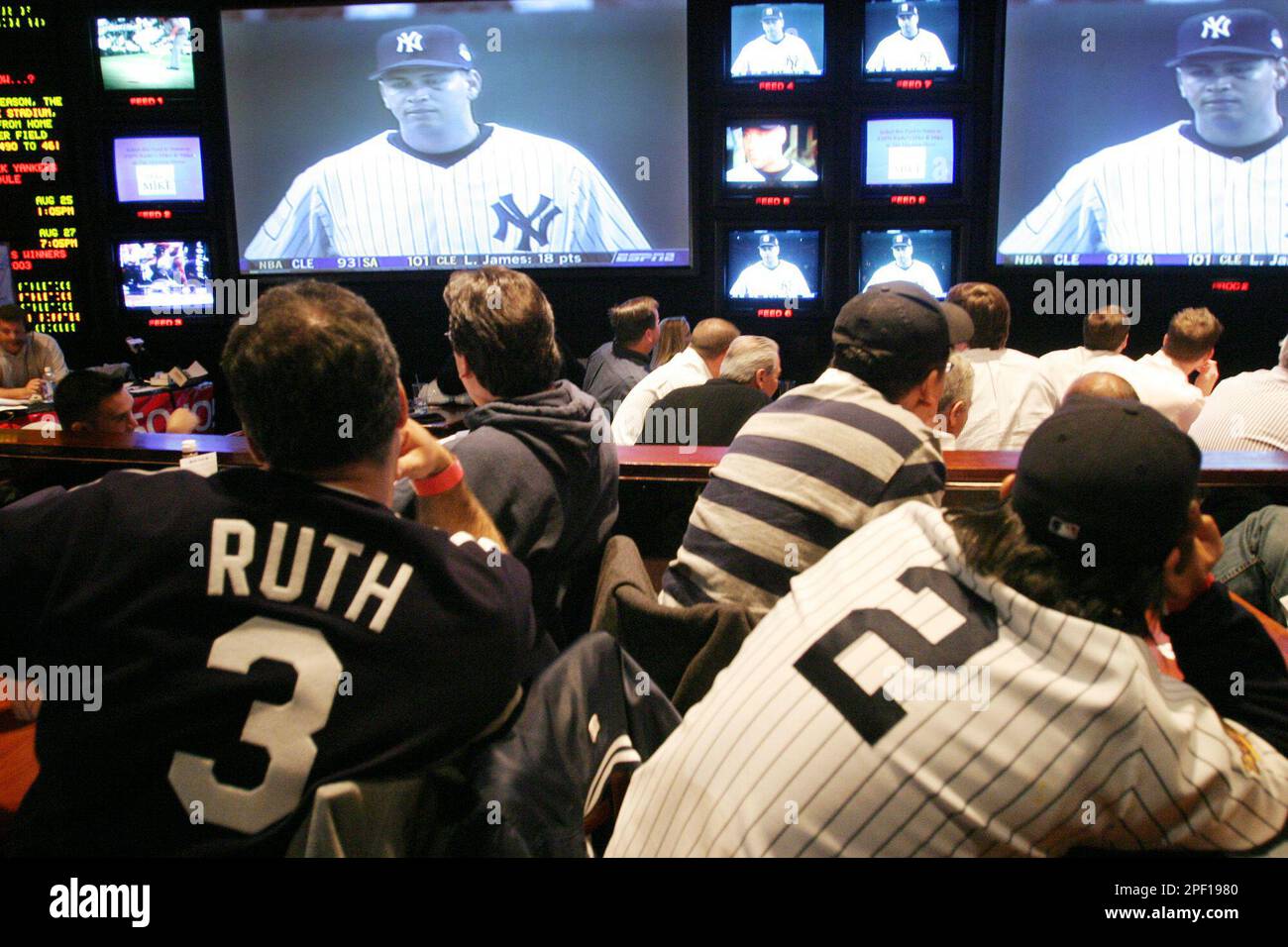 New York Yankees fans watch the opening game of the baseball season at the ESPN Zone Tuesday, March 30, 2004 in New York