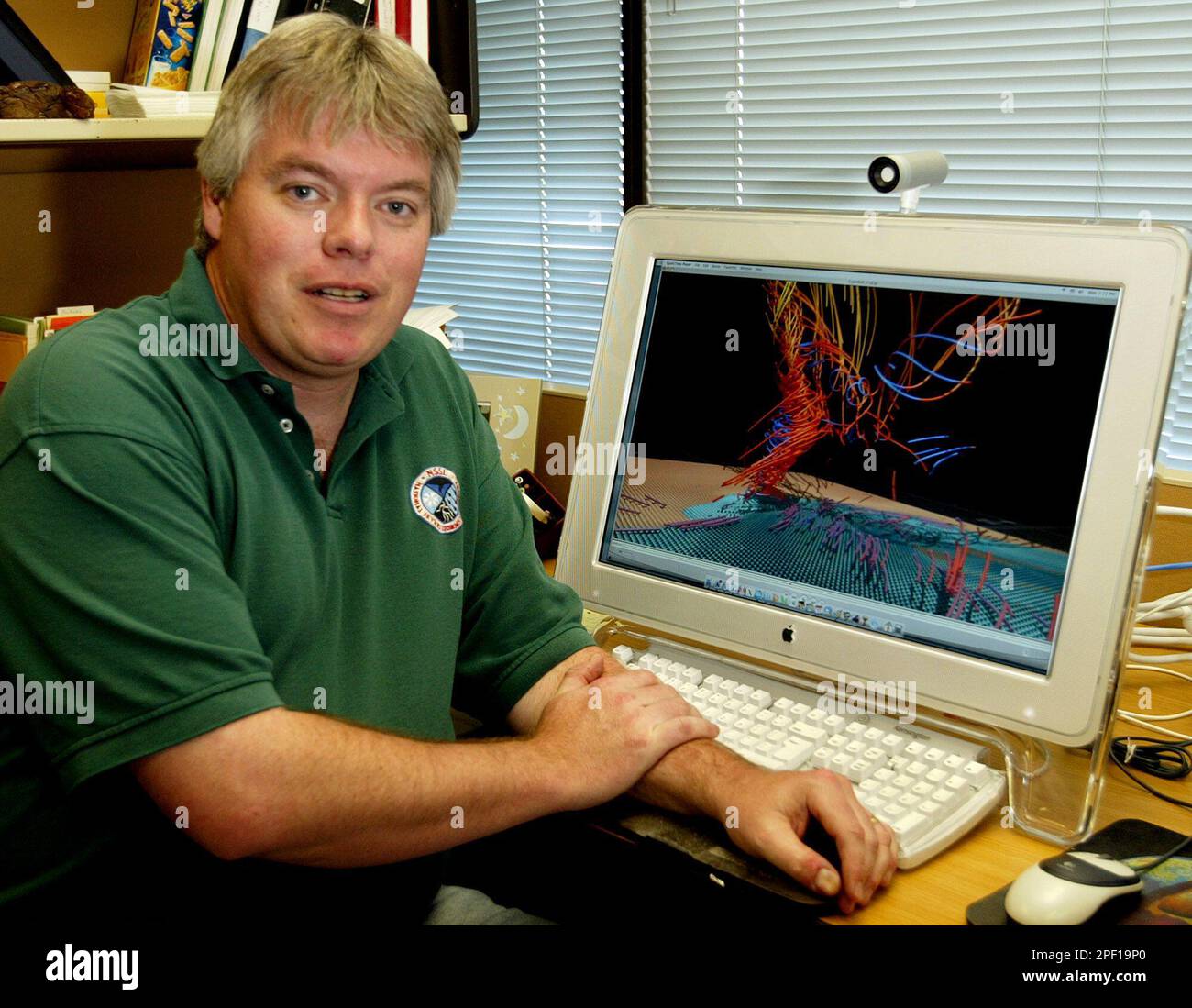 Lou Computers Research meteorologist Lou Wicker poses next to his computer which ...