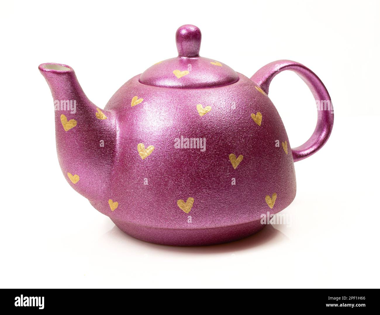 Fancy and shiny ceramic teapot with painted hearts on isolated on white background Stock Photo