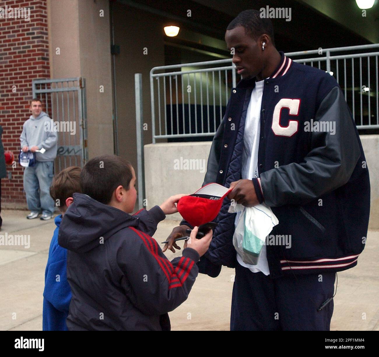 Connecticut&rsquo;s Emeka Okafor signs an autograph for a young admirer after