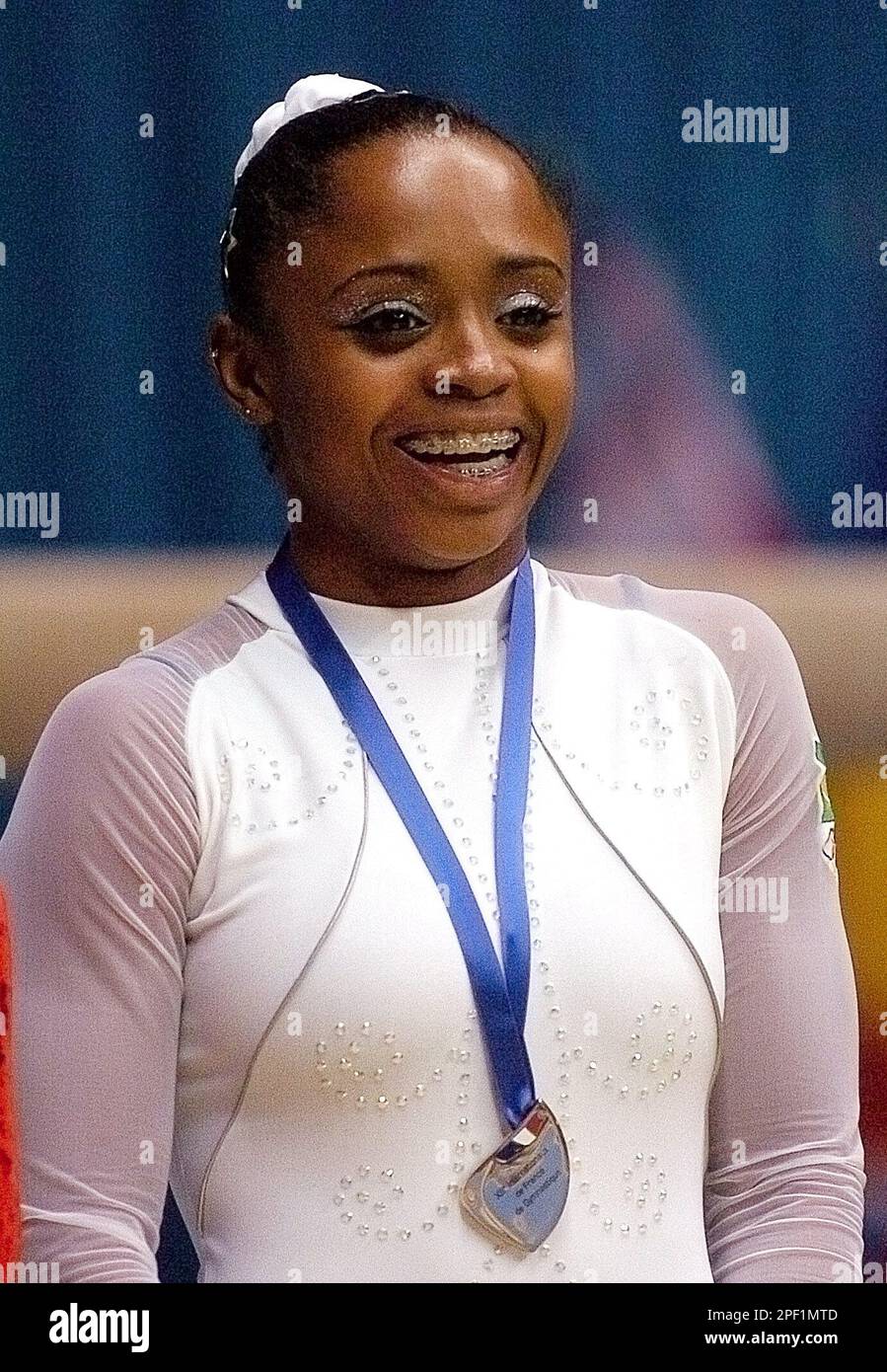 Daiane Dos Santos of Brazil smiles on the podium after winning the gold medal in the floor exercise, during the gymnastics world cup event held in Lyon, central France, Sunday March 14, 2004. (AP Photo/Patrick Gardin) Stock Photo