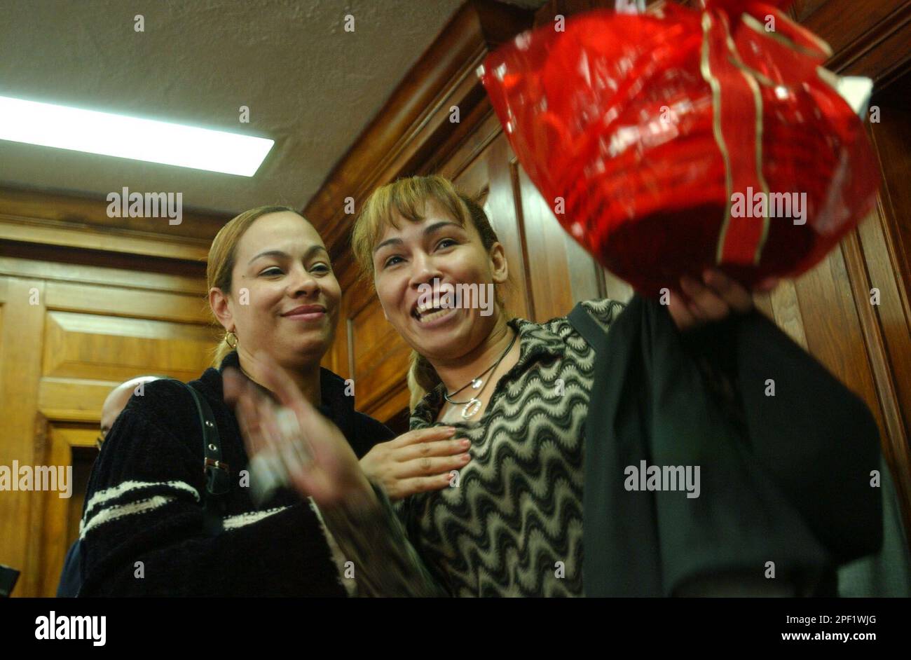 Luz deJesus, left, hugs her sister Luzaida Cuevas after announcing a