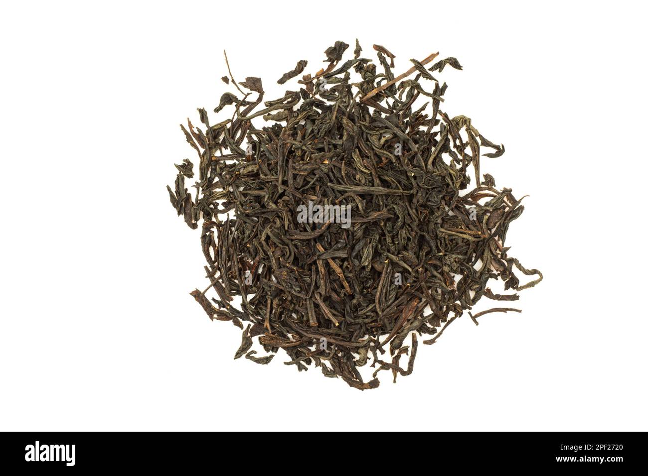 Pile of dry black indian tea isolated on white background. Aromatic herb Stock Photo