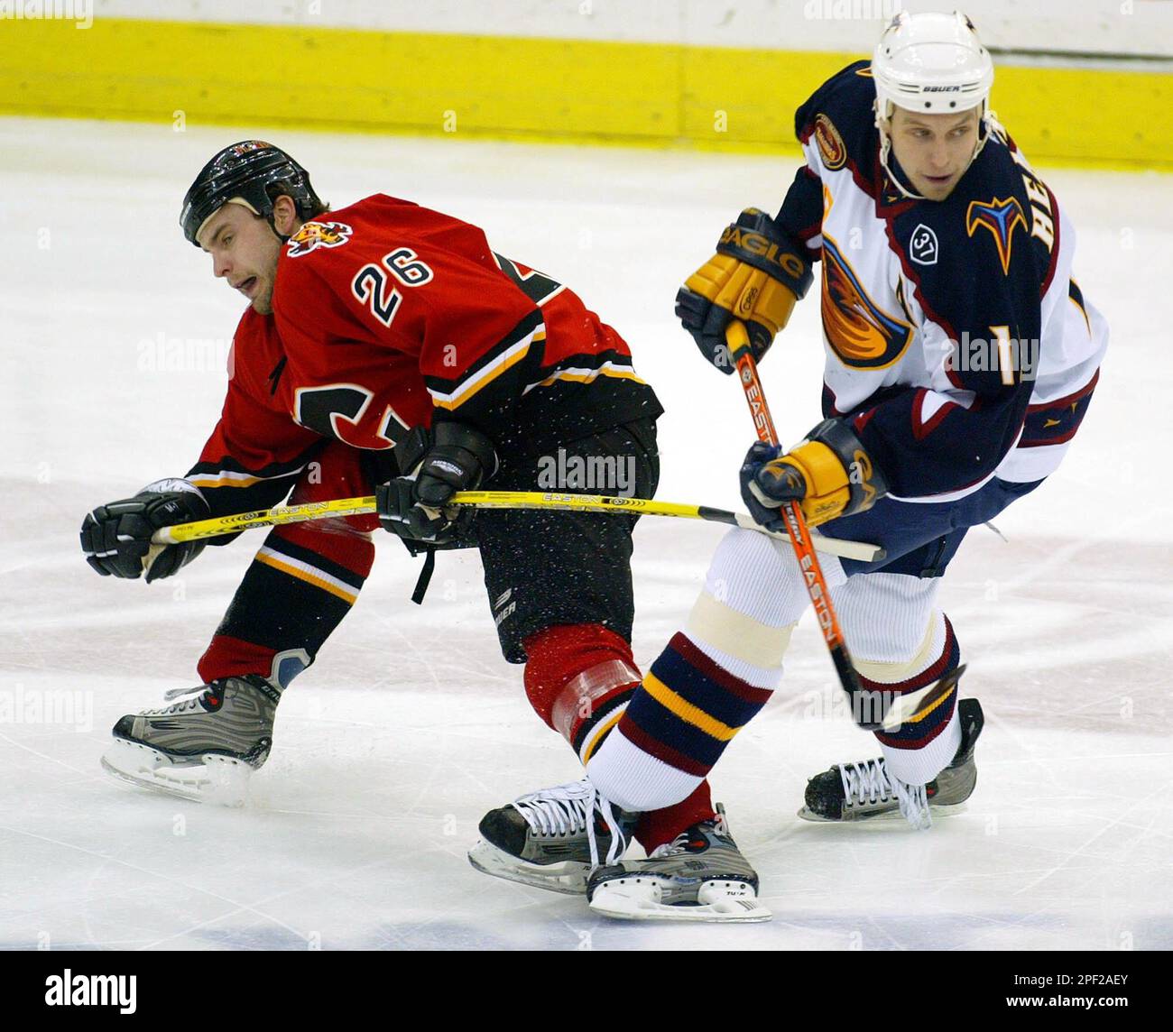 Atlanta Thrashers right wing Dany Heatley, right, hits the puck away from  Pittsburgh Penguins center Mike Eastwood on Friday, April 2, 2004, in  Atlanta. (AP Photo/Matt Roth Stock Photo - Alamy