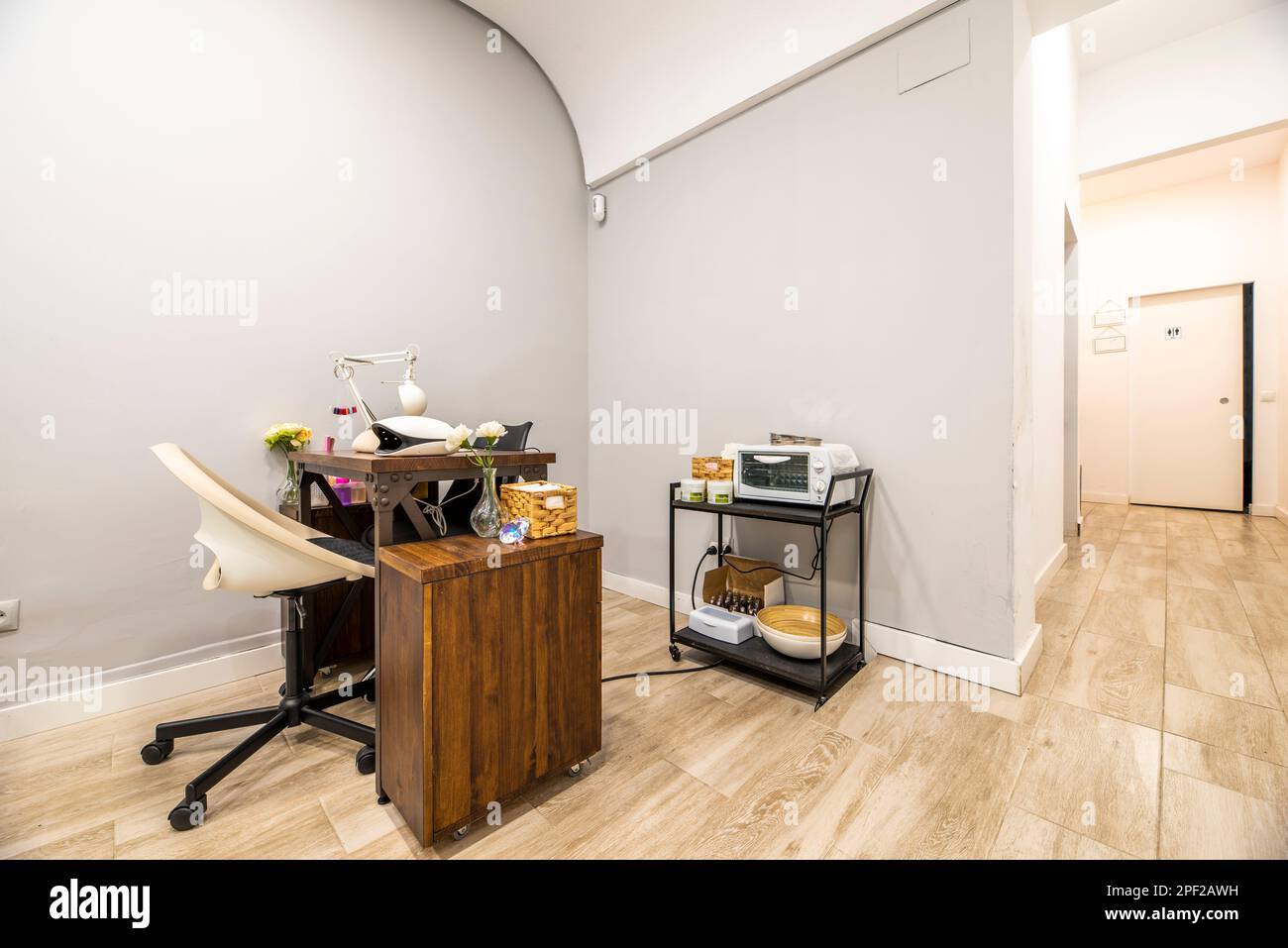 Wooden nail salon table with swivel chair with black leg and white