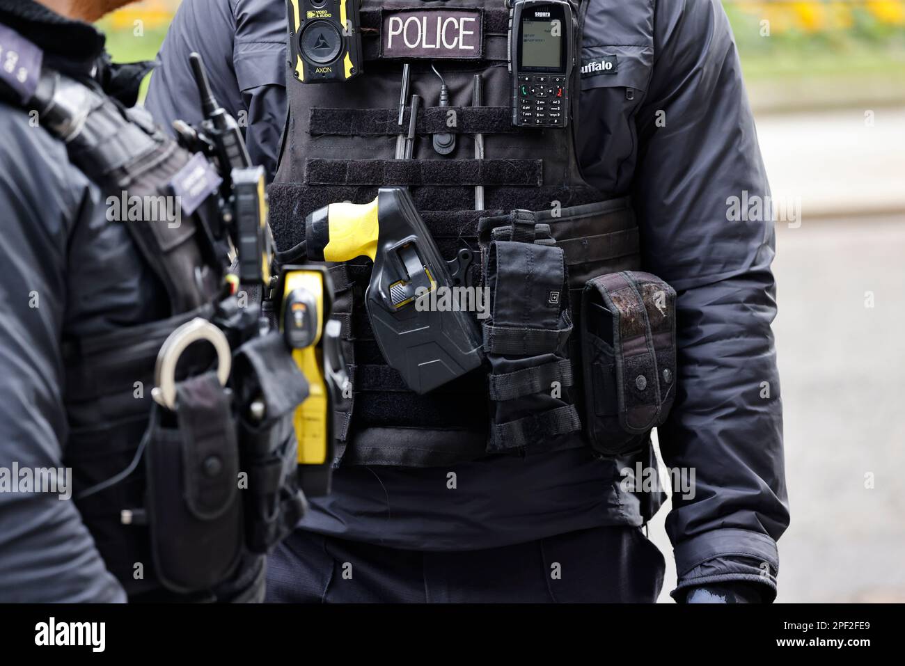 England, London, Westminster, Downing Street, Detail of AFO Police officers wearing body protection with radio, taser gun and handcuffs. Stock Photo