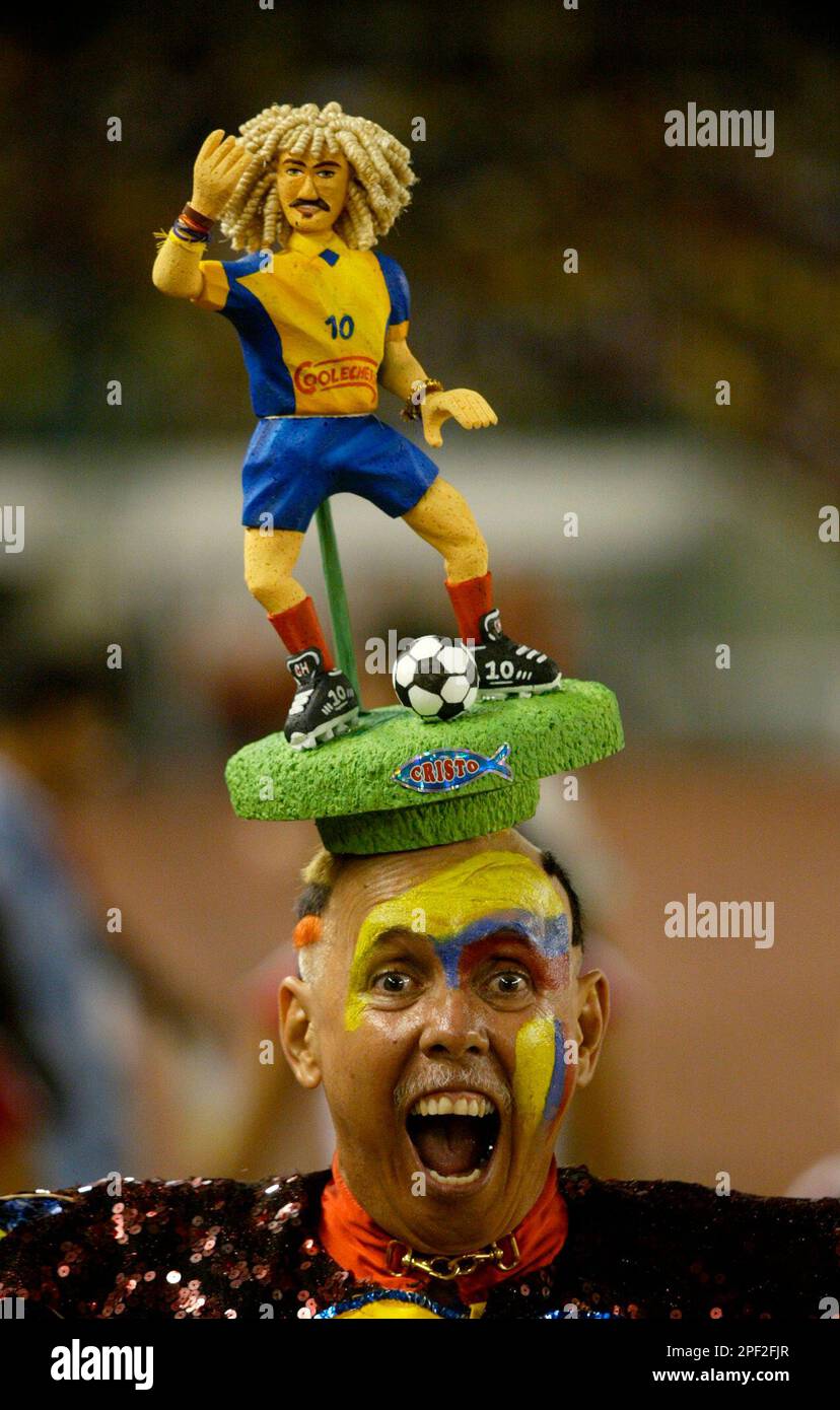 A fan wears a hat with a figure of Carlos 