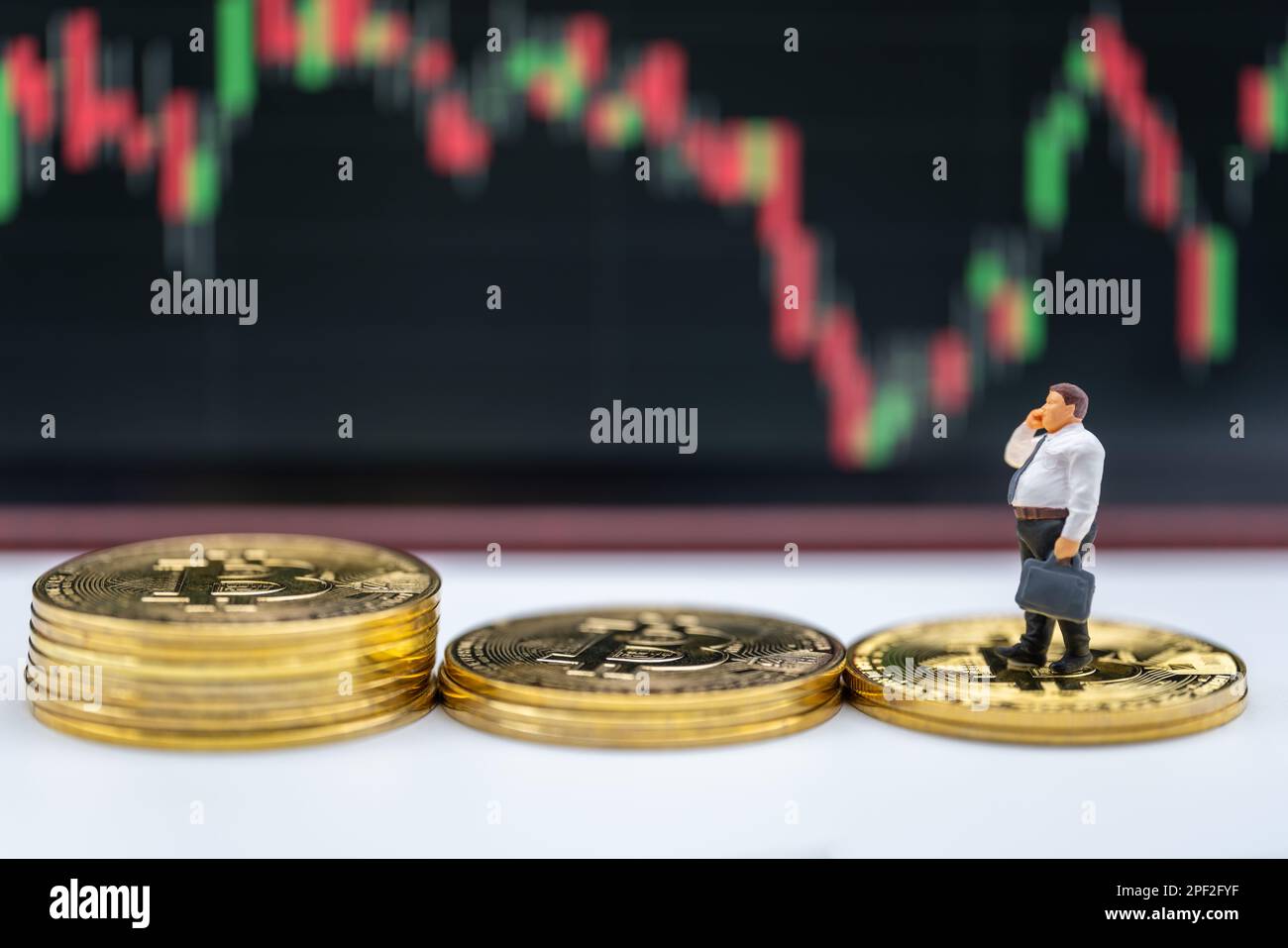 Business Money and Financial Concept. Fat businessman miniature figure people  make a phone call and holding hand bag walking on stack of gold Bitcoin  Stock Photo - Alamy