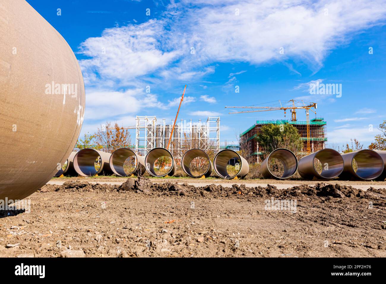 Many concrete pipes with durable ceramic glaze and large diameter for chemical waste are stacked waiting to built-in. Stock Photo