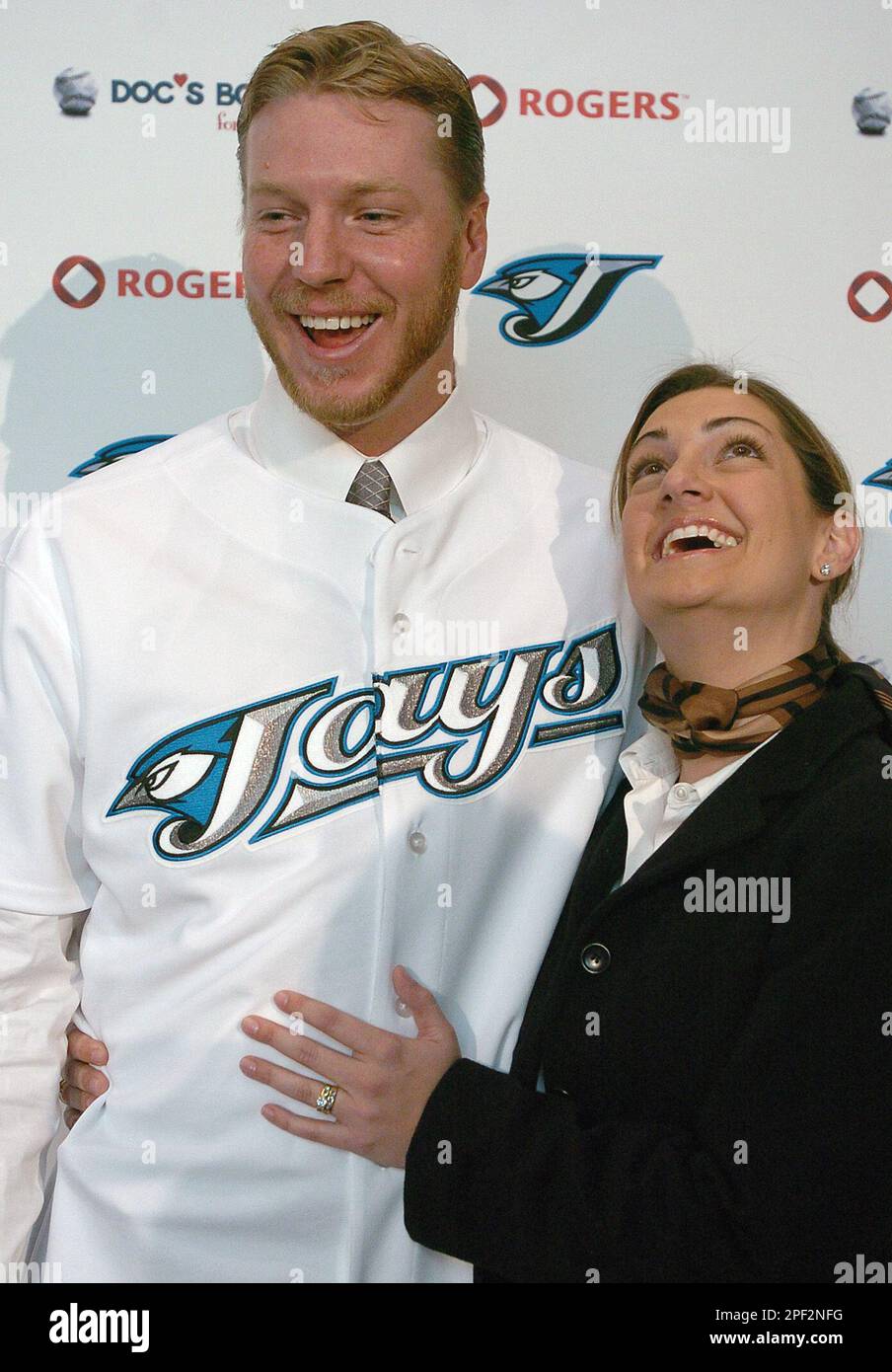 Toronto Blue Jays pitcher Roy Halladay, left, and his wife Brandy smile  following a press conference in Toronto, Thursday Jan. 22, 2004. Halladay  signed to a four year, $42 million contract with