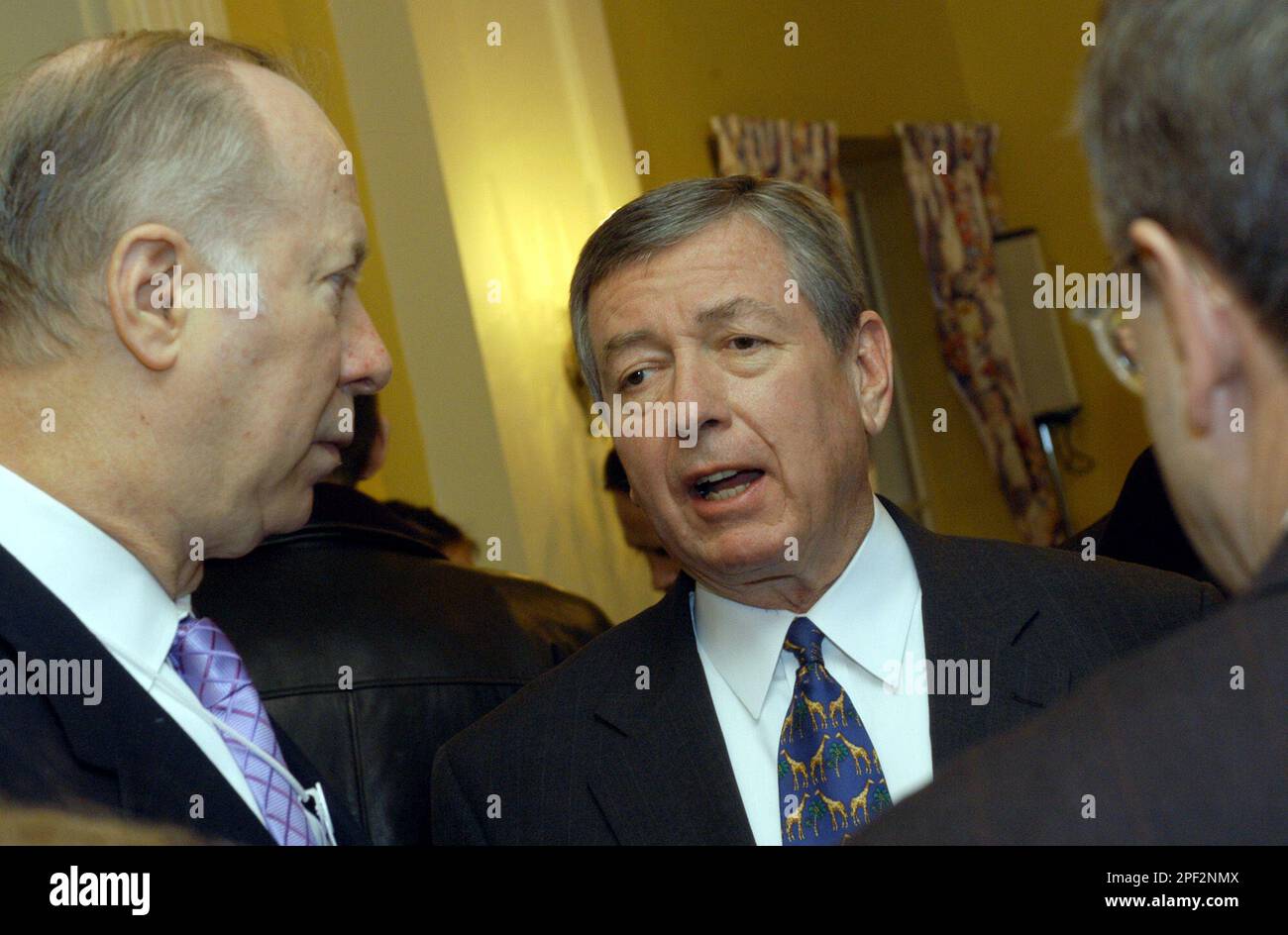 US AttorneyGeneral John Ashcroft, center, talks to David R. Gergen