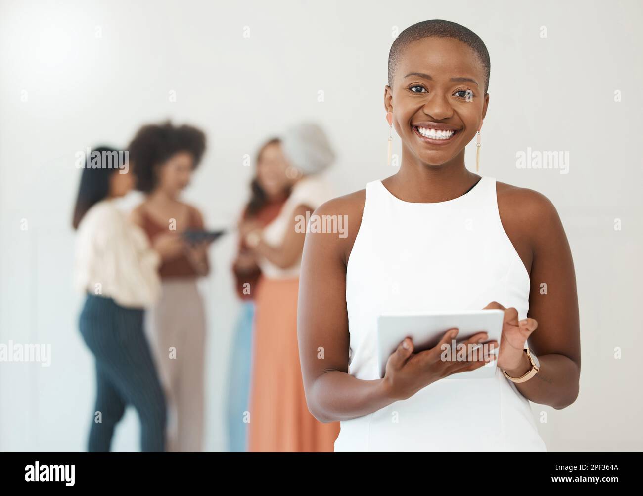 Portrait of a young happy african american businesswoman holding and ...