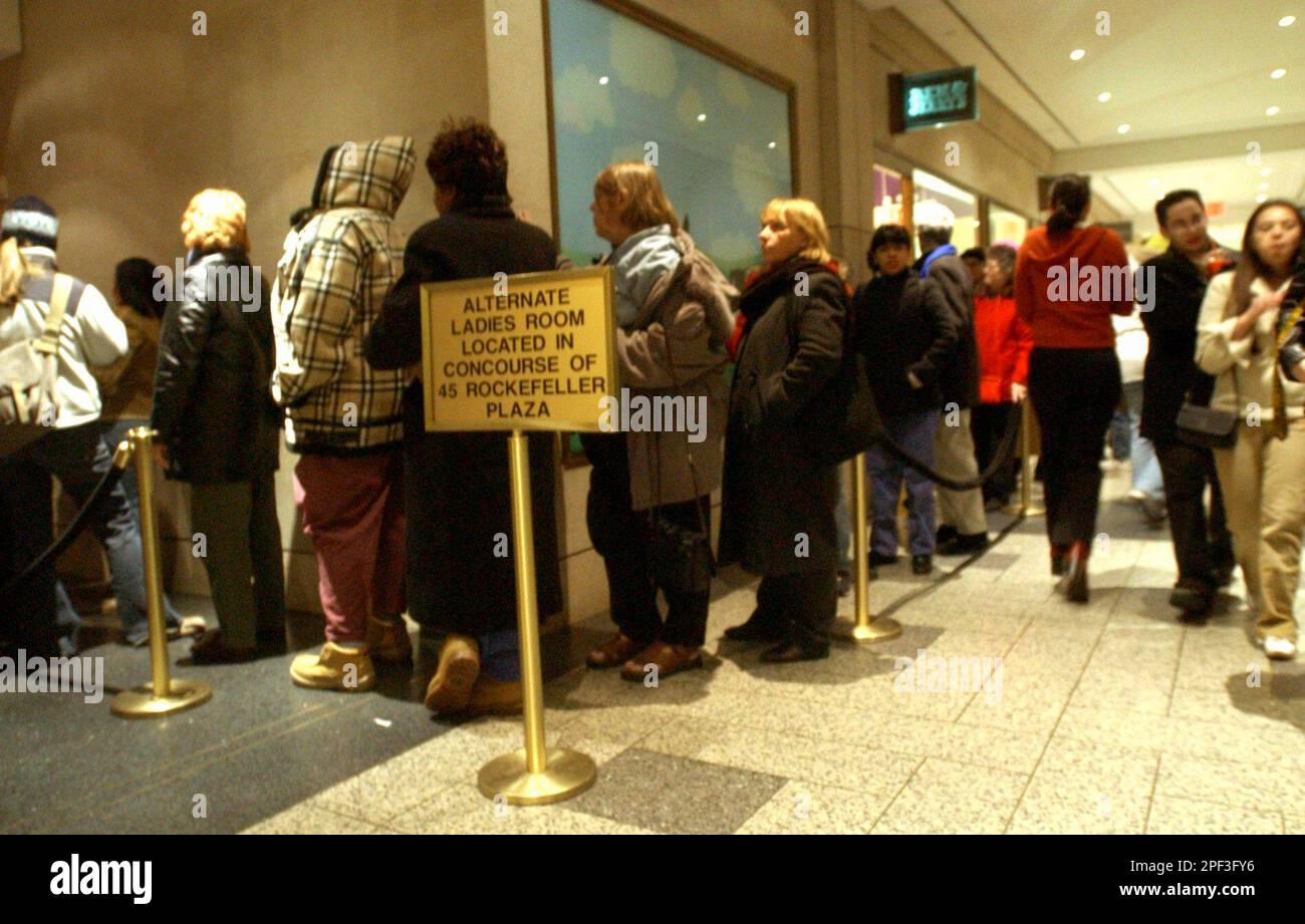 Women wait in line to use an alternate restroom at Rockefeller Plaza in ...