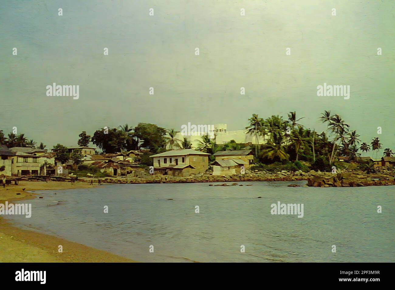 The beach and Fort Metal Cross (previously known as Fort Dixcove) in Dixcove, Ghana c.1959 Stock Photo