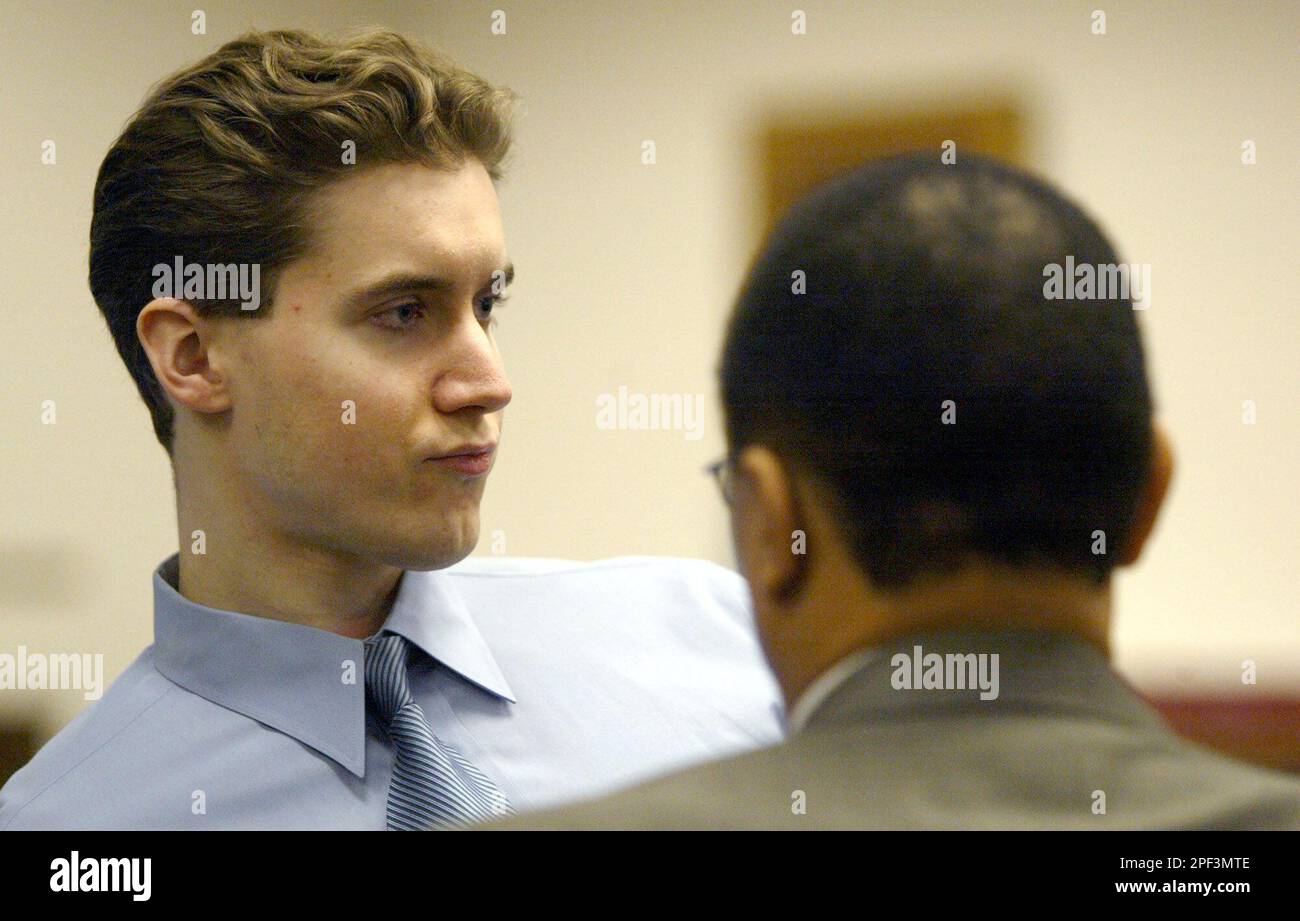 Sebastian Burns, left, talks to one of his attorneys in a King County