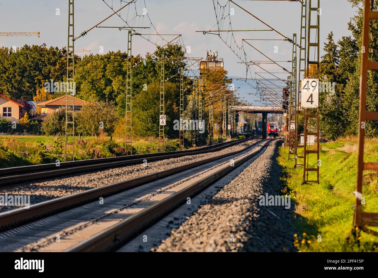 Straight track layout and rails with a bridge and track bed with ballast and overhead wires Stock Photo