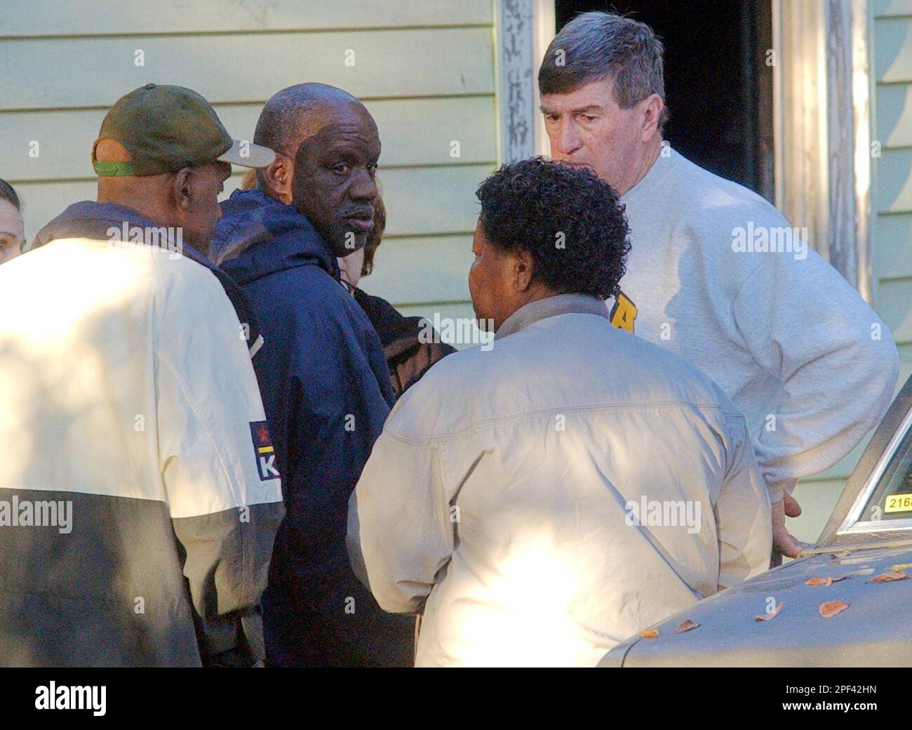Harold Jones, right, talks with James "Radio" Kennedy, center, Kennedy's  brother, Walter, left, and Walter's wife, Mary, outside the the Kennedy's  house on Railroad Street in Anderson, S.C., Saturday, Nov. 1, 2003.