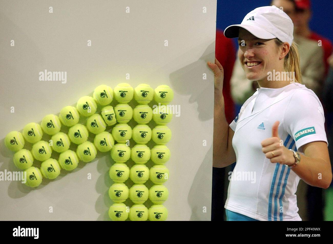 Justine Henin-Hardenne of Belgium poses in front of a number one made of tennis  balls after winning the final against Jelena Dokic of Serbia-Montenegro at  the Swisscom Challenge Tennis Tournament in Kloten,
