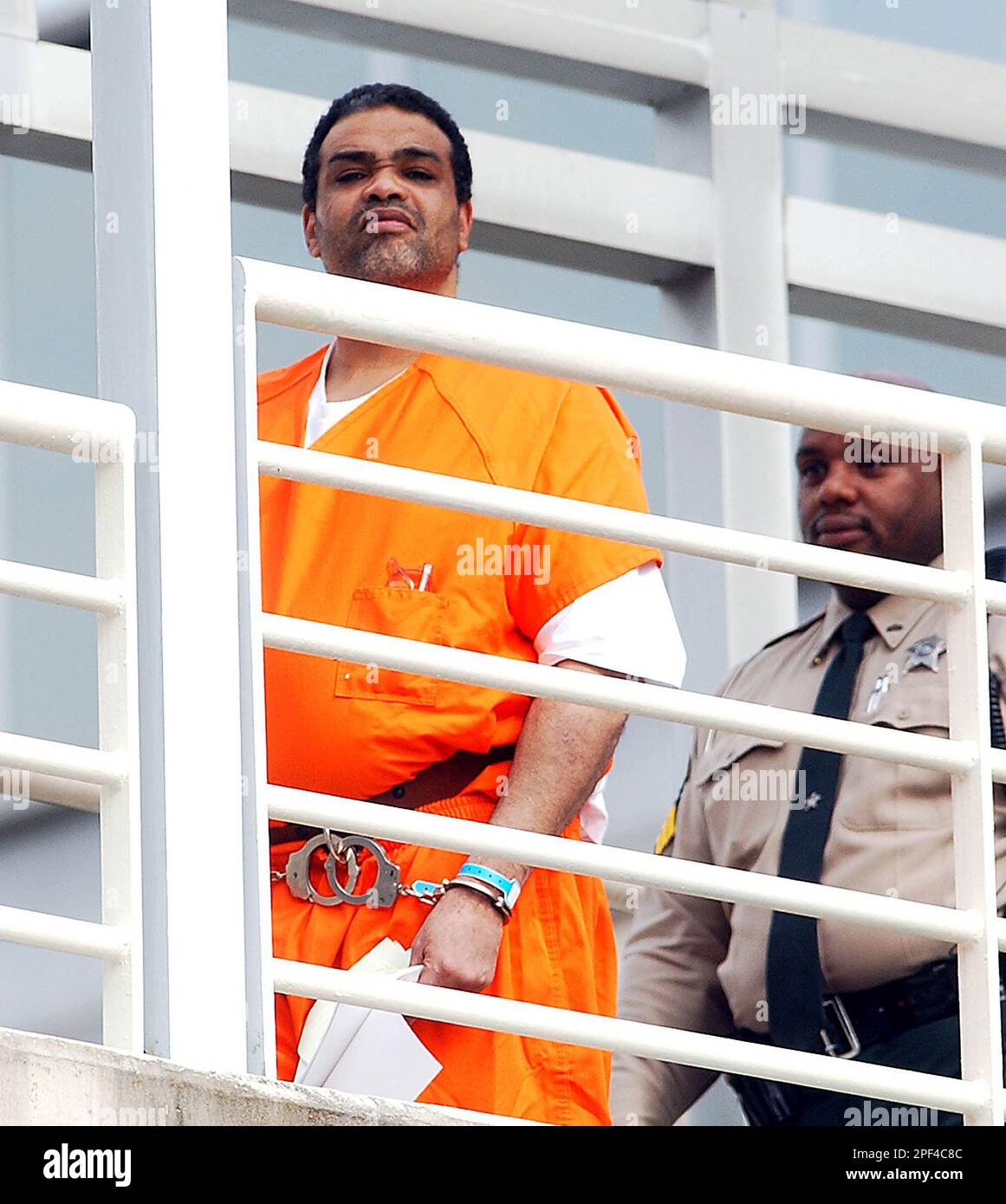 Van Brett Watkins, left, is escorted by a Mecklenburg County Sheriff