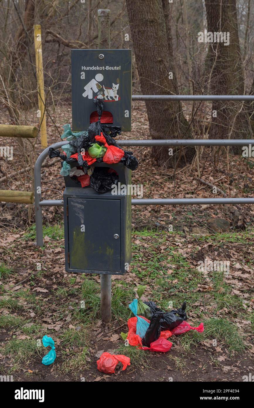 Overcrowded collection point for dog excrement bags in the meadow meadows of the Pegnitz, Bavaria, Germany Stock Photo