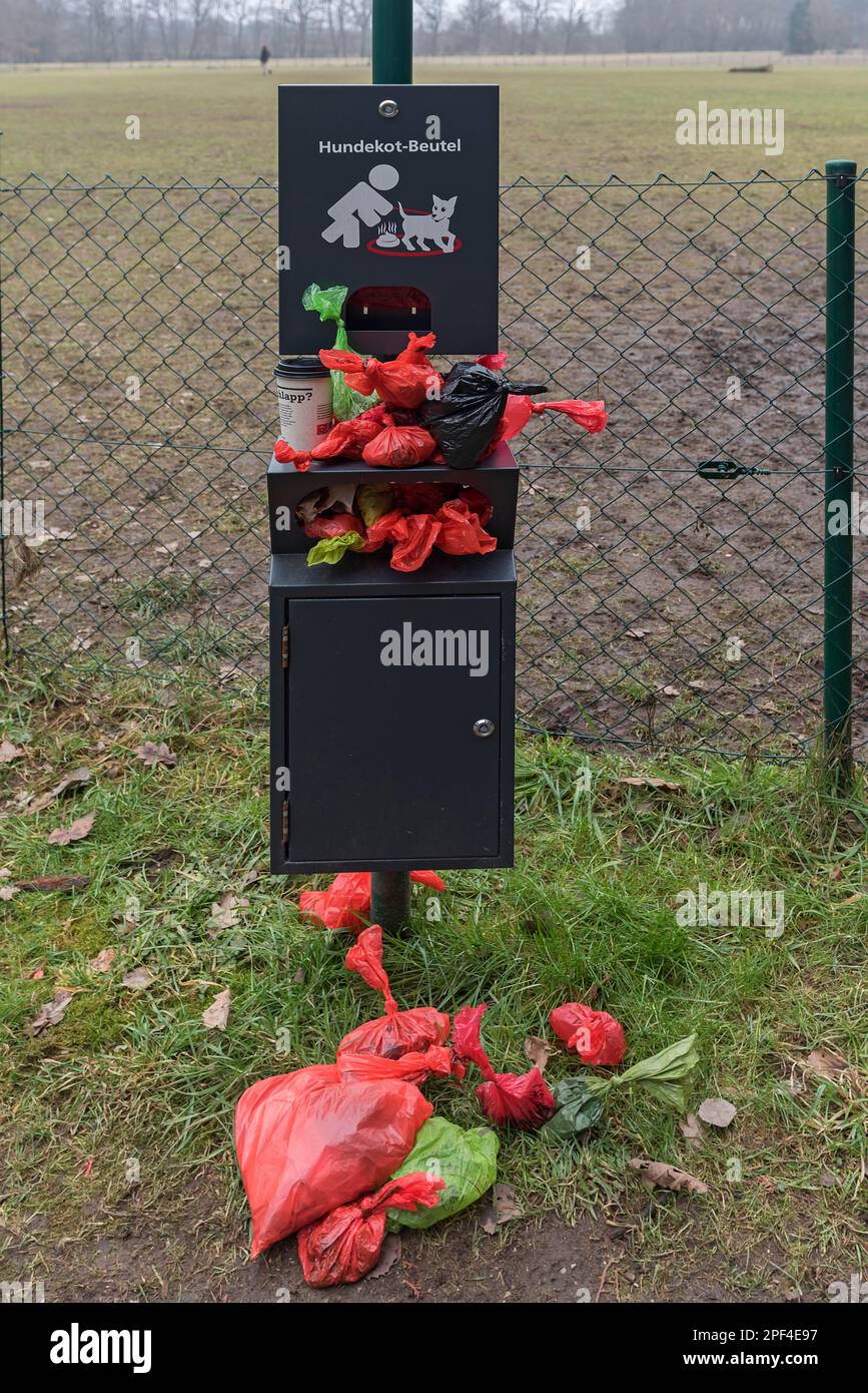 Overcrowded collection point for dog excrement bags in front of a dog playground, Bavaria, Germany Stock Photo