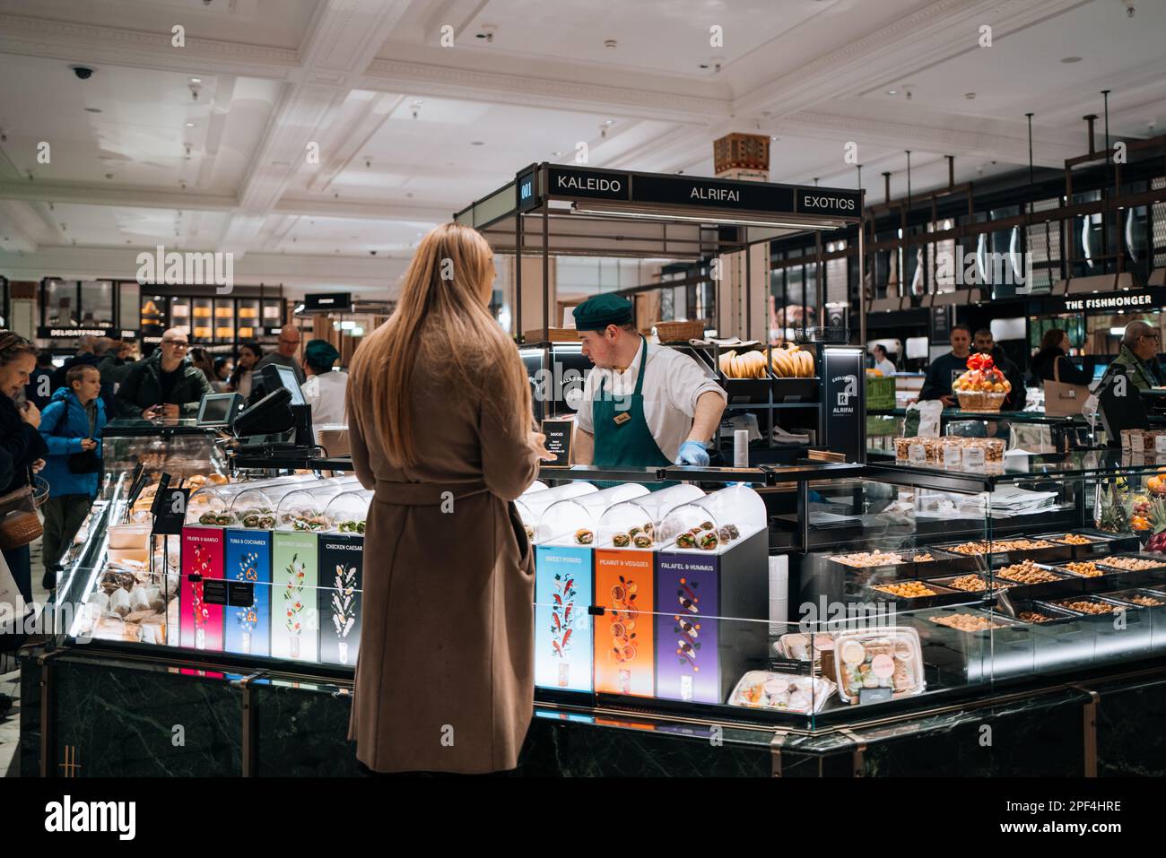 London, UK - February 21, 2023: Staff working at the food hall inside Harrods, a famous department store located on Brompton Road in Knightsbridge, Lo Stock Photo