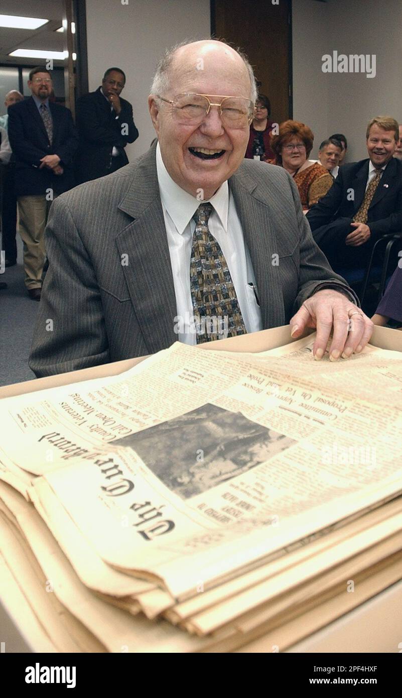 Pulitzer Prizewinning reporter Ken Towery poses with some of The Cuero