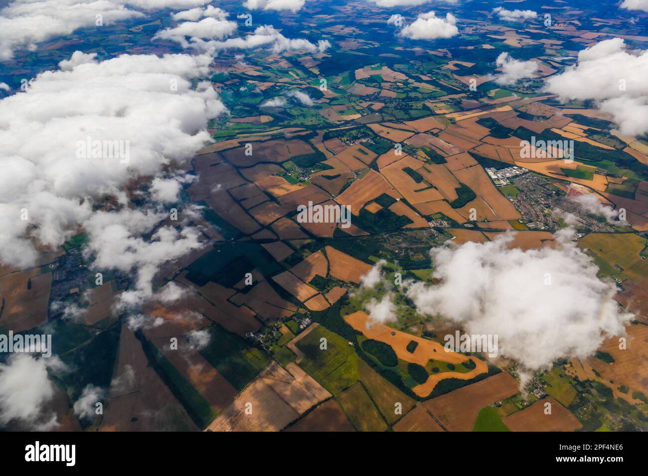 Aerial view from aeroplane of the Essex countryside partially covered in clouds. Stock Photo