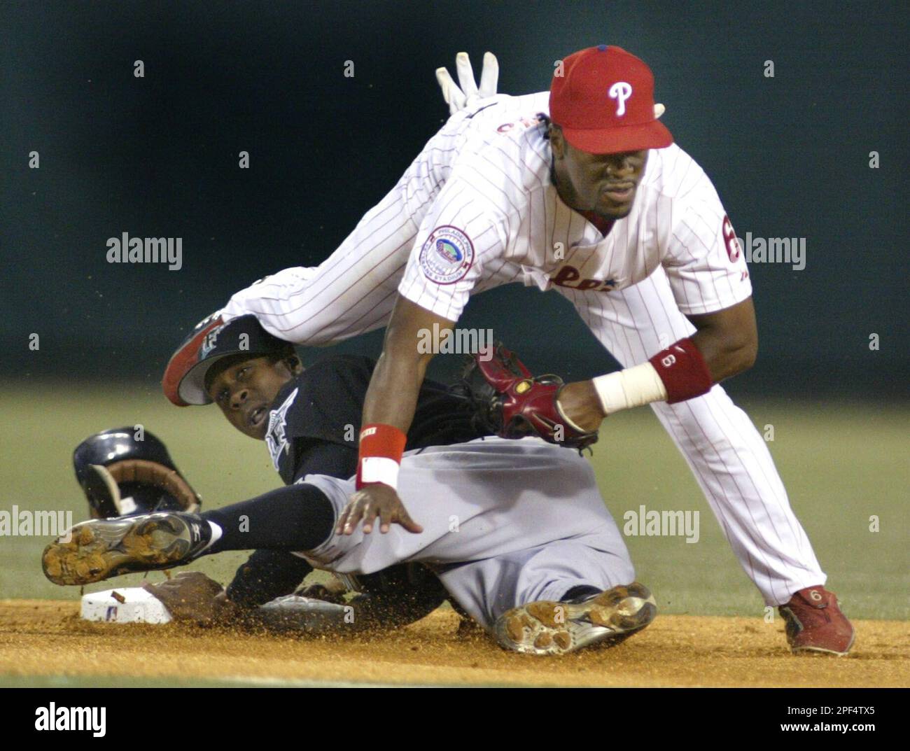 Florida Marlins' Juan Pierre steals second base under Philadelphia Phillies  infielder Jimmy Rollins during the first inning Wednesday, Sept. 17, 2003,  in Philadelphia.(AP Photo/Miles Kennedy Stock Photo - Alamy