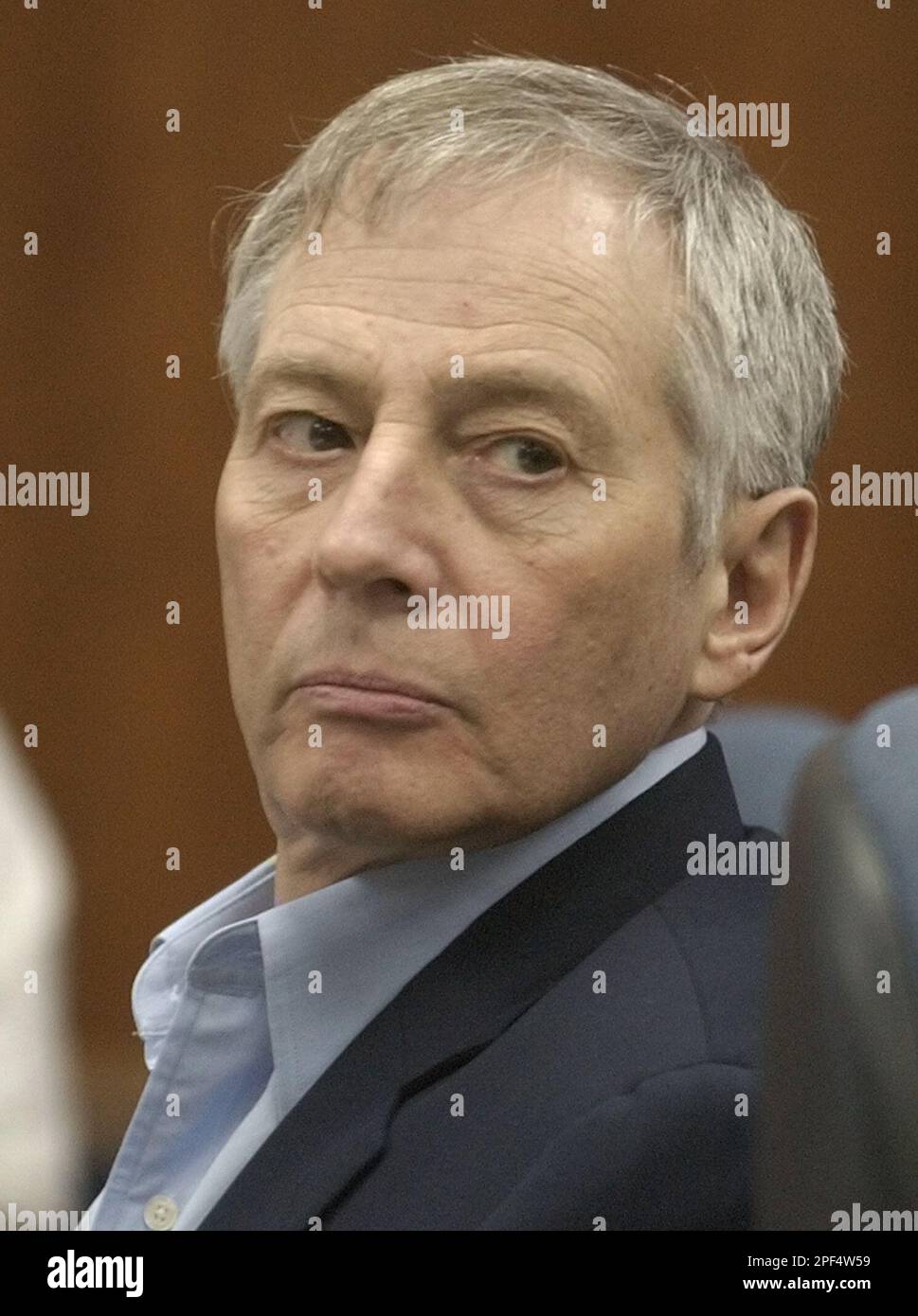 Millionaire murder defendant Robert Durst, left, looks away during jury