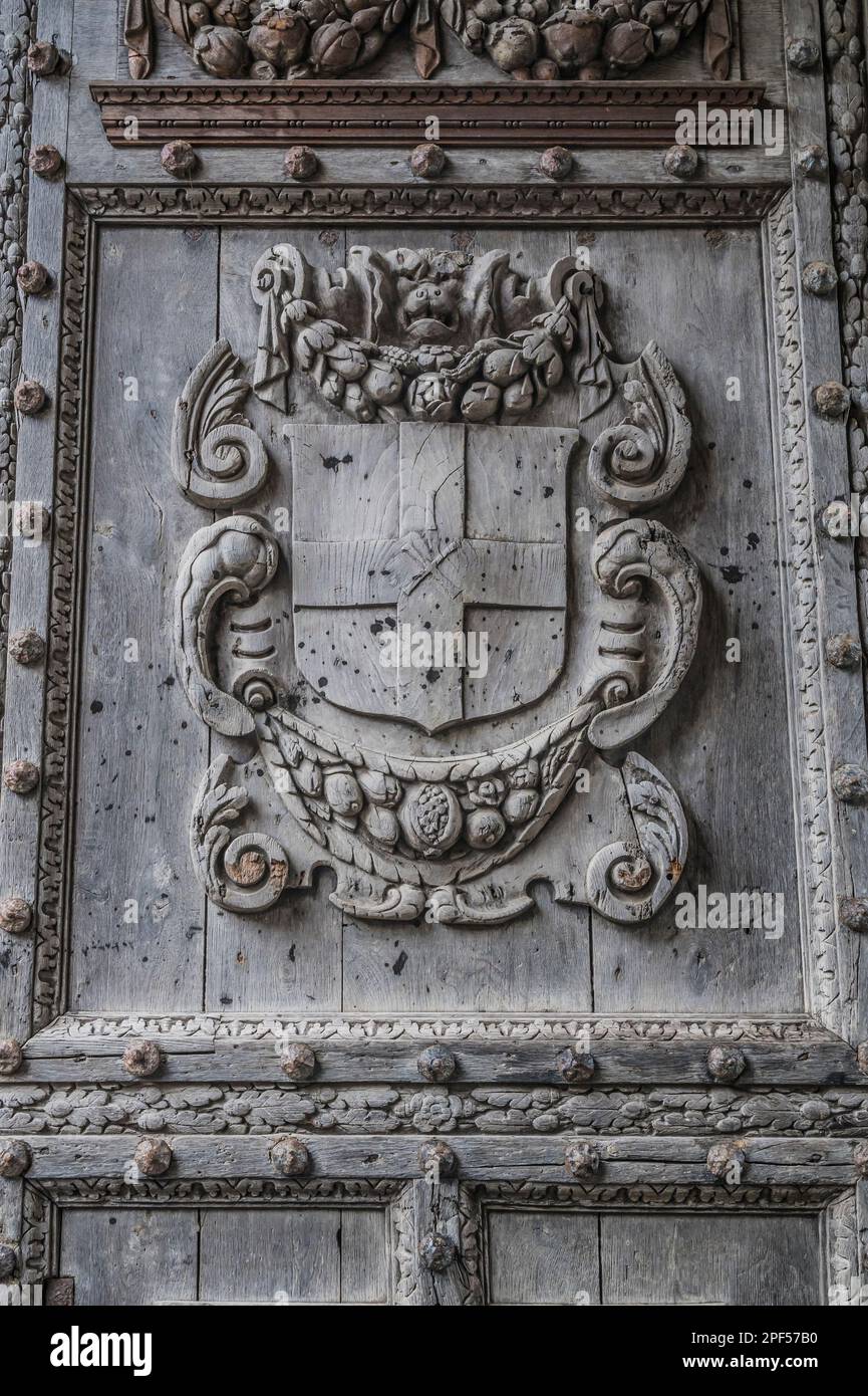 The image is of heraldic coats of arms on the gated door entrance to the famous World Heritage Site of Canterbury's Christ Church Cathedral in Kent. Stock Photo