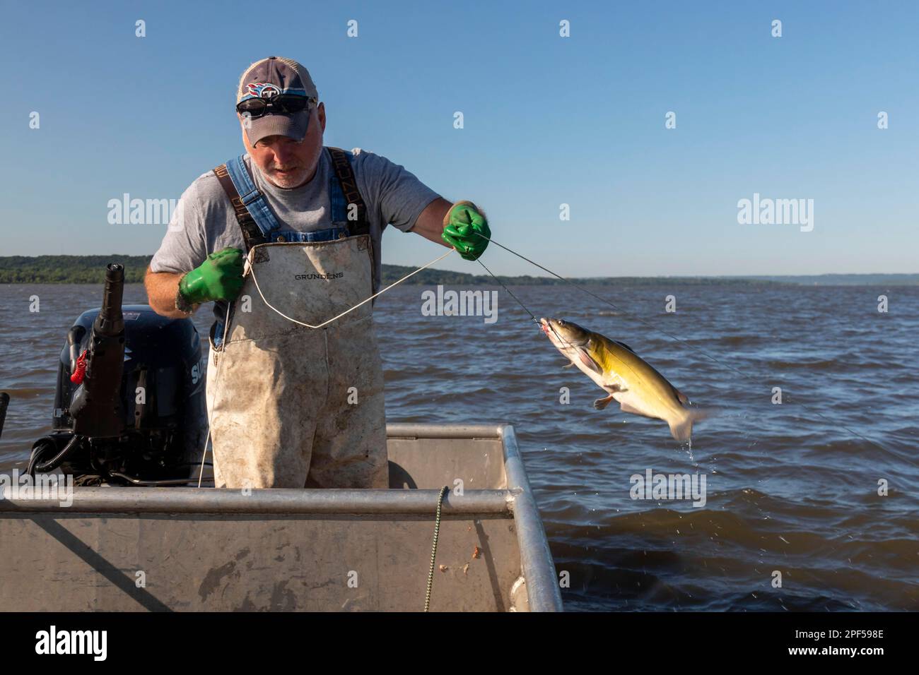 Peoria, Illinois, Dave Buchanan fishes for catfish on the Illinois River.  He uses a trotline--a long line from which a hundred or more baited hooks  Stock Photo - Alamy