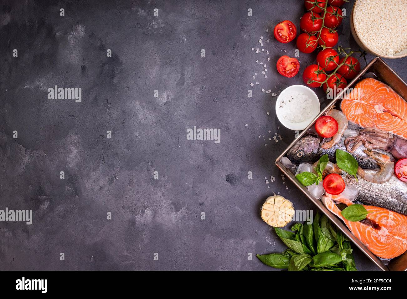 Assorted fish and seafood. Raw fresh salmon steak, trout, squid