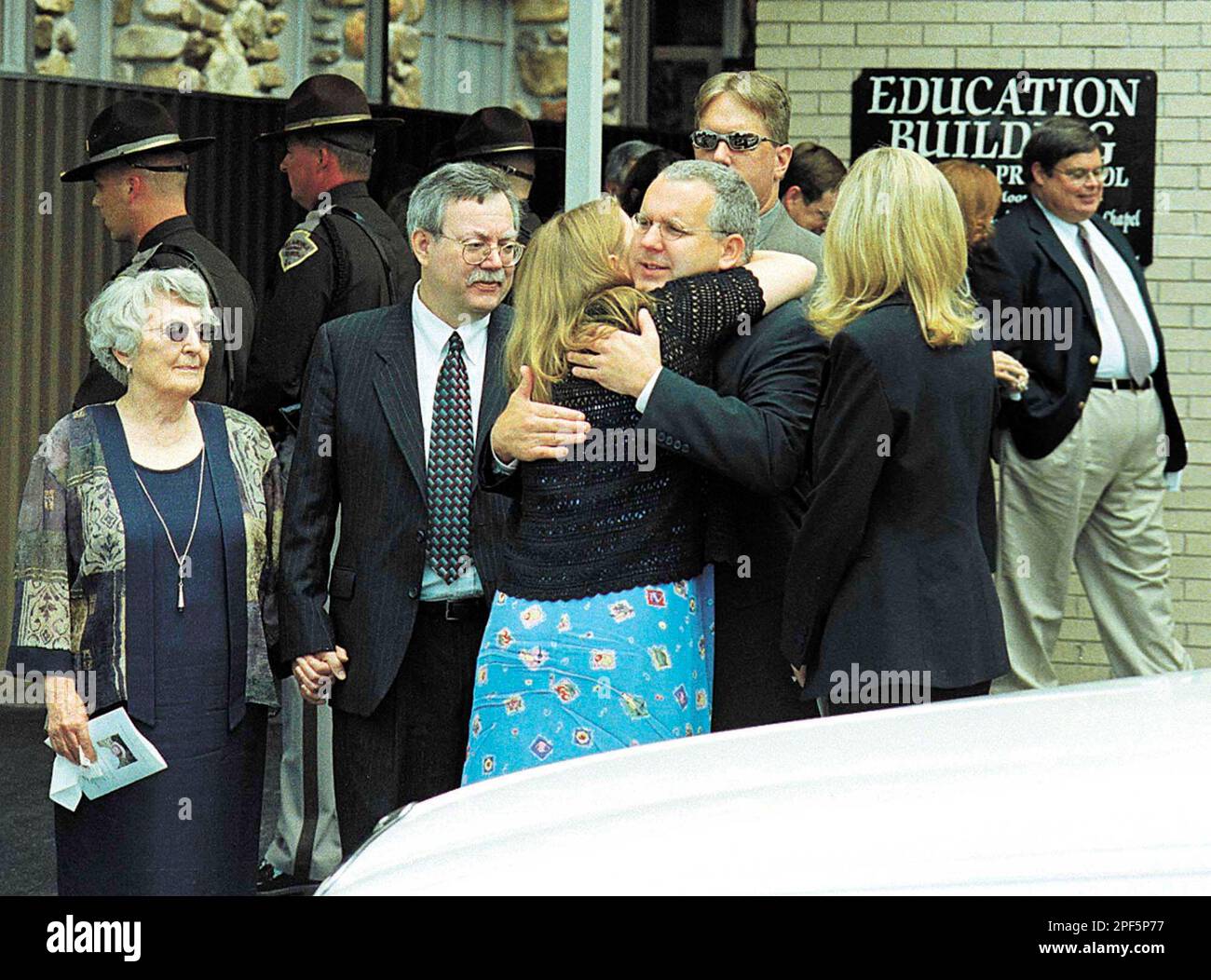 Oklahoma Gov. Brad Henry, with first lady Kim Henry standing at right,  receives a hug following funeral service for his mother Audre' L. Henry,  Saturday, Aug. 2, 2003, in Shawnee, Okla. She
