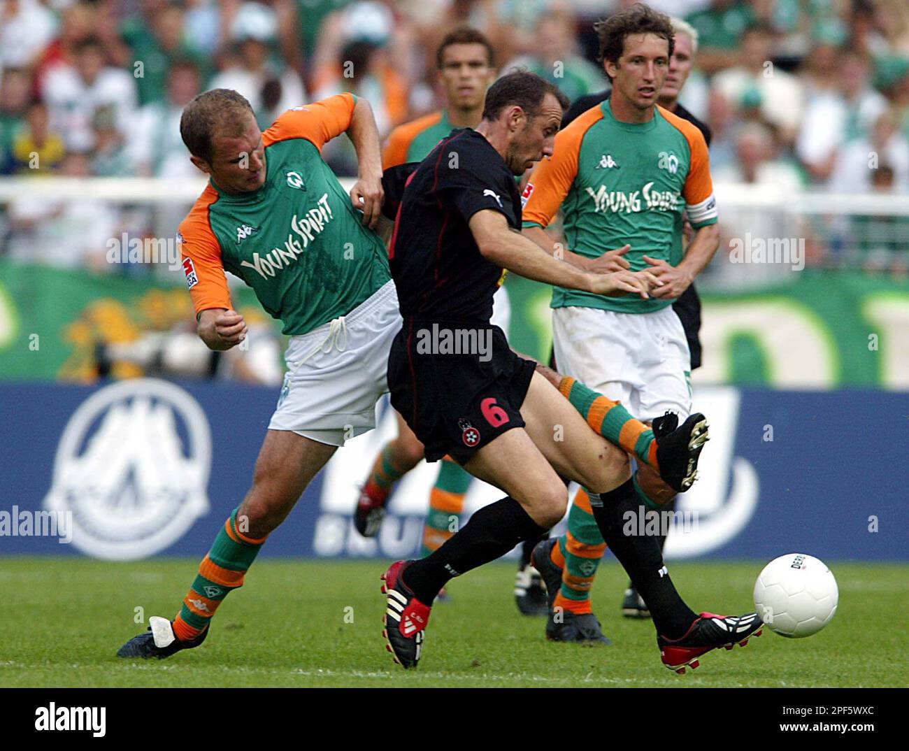 bremens ivica banovic left struggles with eric roy of nice while frank baumann right watches the scene during the uefa ui cup soccer match between werder bremen and ogc nice at the bremer weser stadium germany saturday july 26 2003 ap photofrank augstein 2PF5WXC