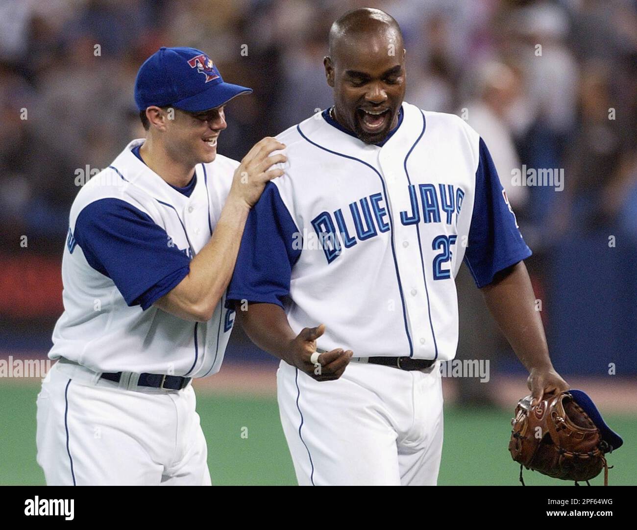 Toronto Blue Jays' Frank Catalanotto, left, and teammate Carlos Delgado  smile as they walk off the