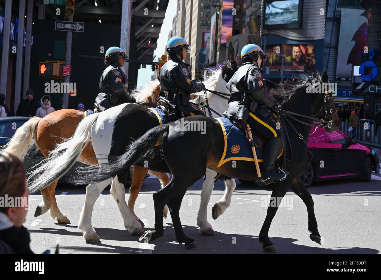 Police officers from the NYPD Mounted Unit ride through Times Square in