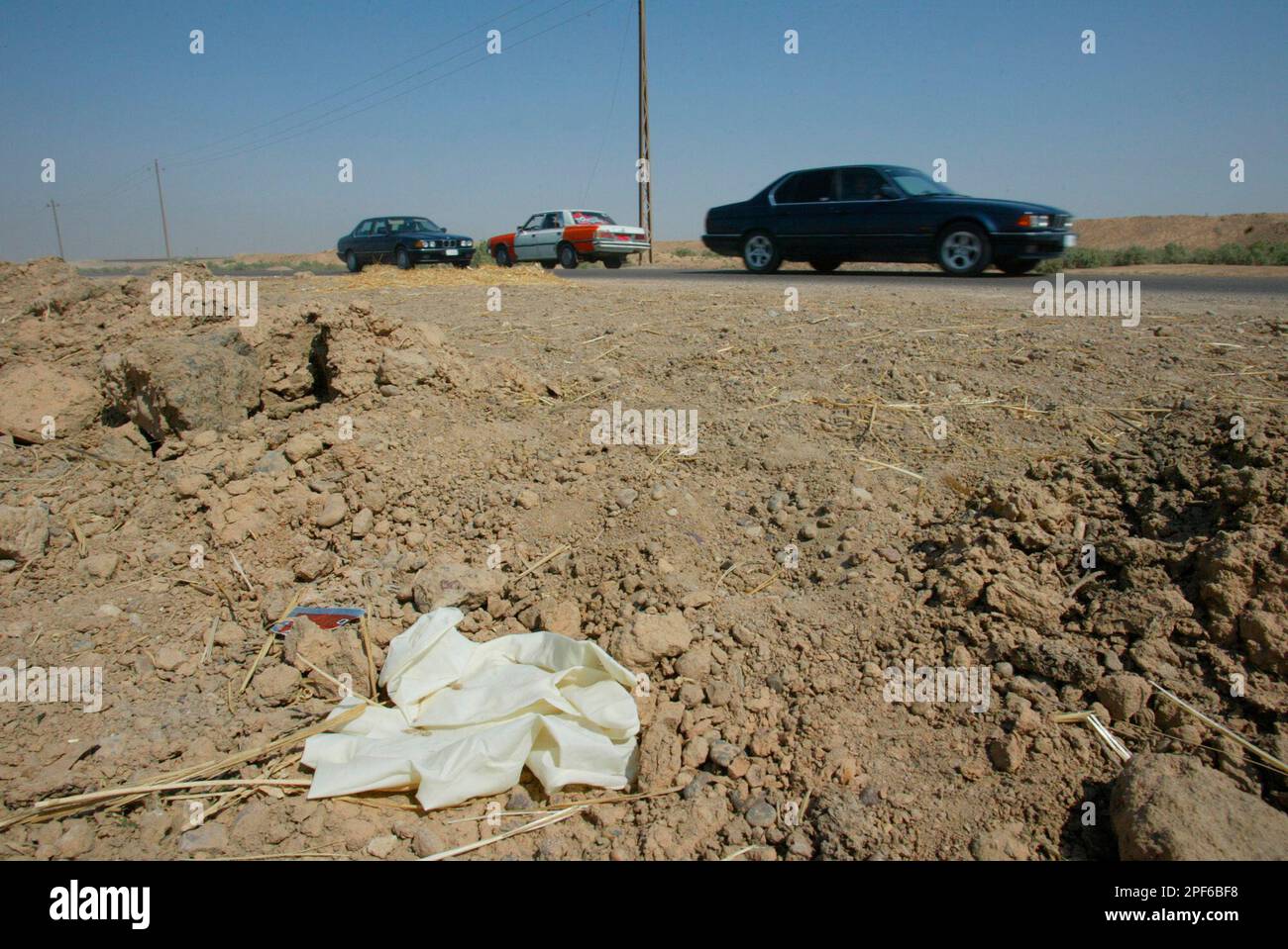 A pair of protective rubber gloves mark the place, Sunday June 29, 2003,  where the remains of two missing soldiers were found 32 kilometers (20  miles) northwest of Baghdad on Saturday. Sgt.
