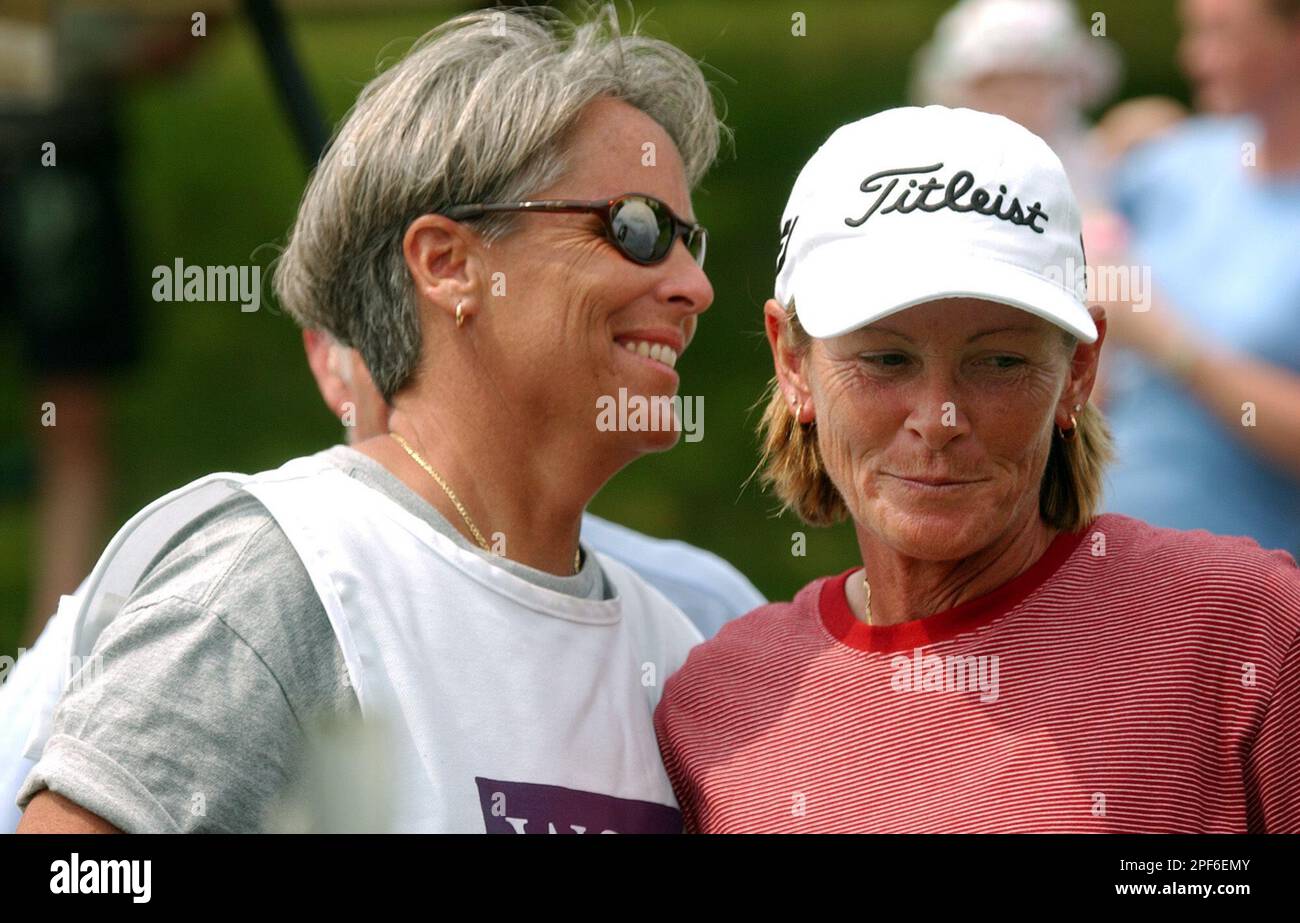 Marilyn Lovander, right, gets a hug from her caddie, Kimmer O'Neill